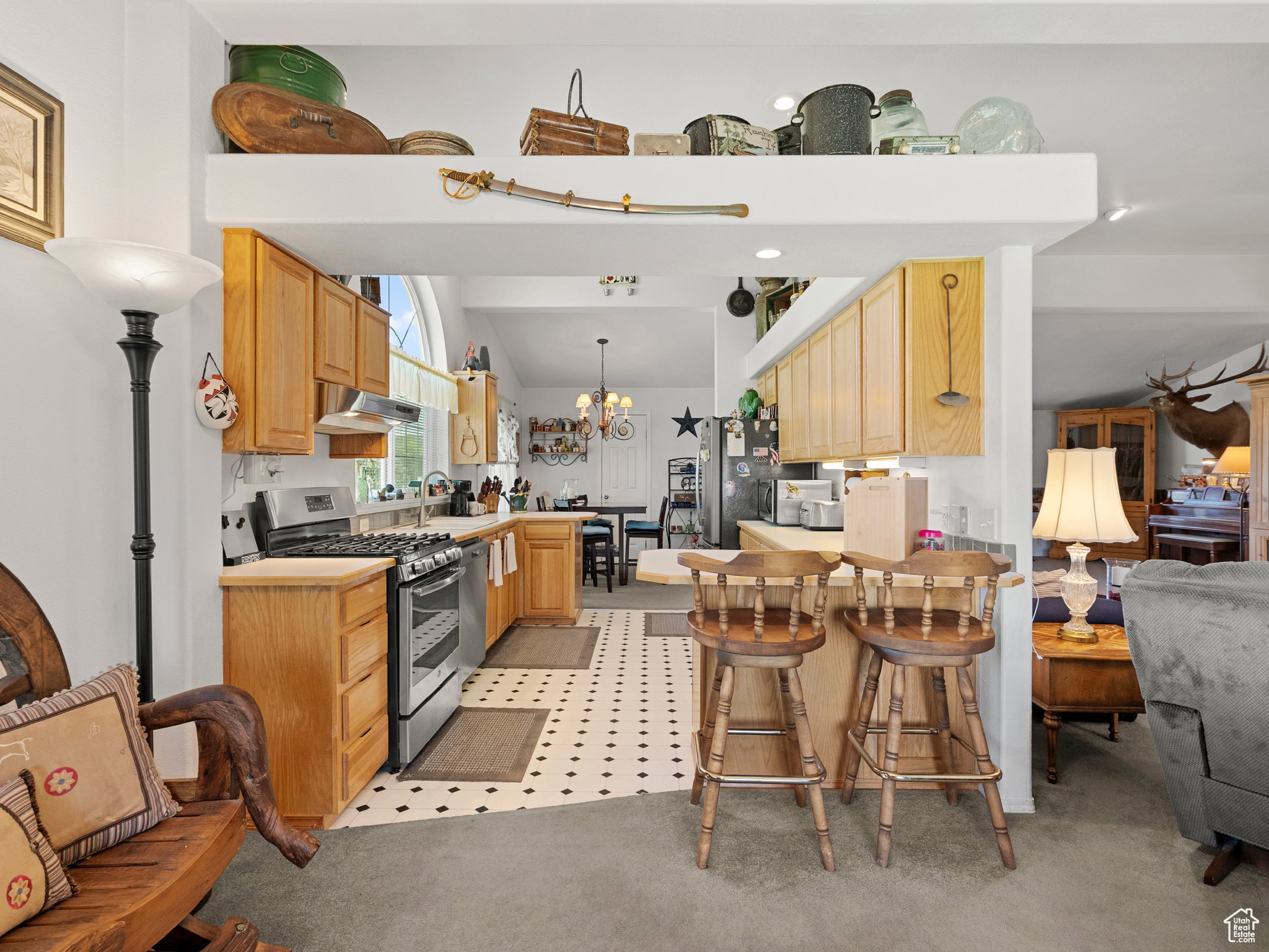 Kitchen with lots of natural light, gas stove and refrigerator included with the home.