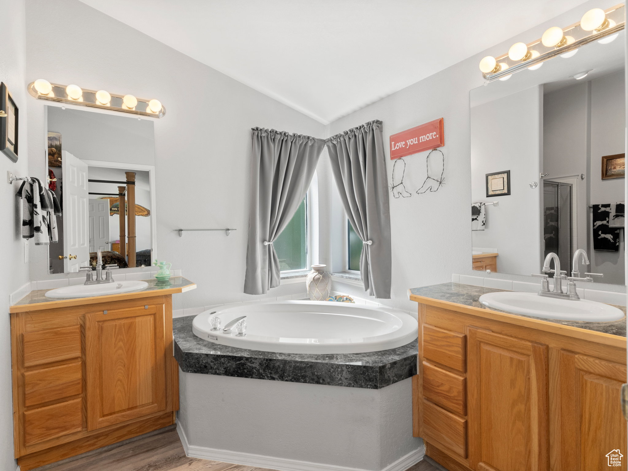 Primary bathroom with standing shower, garden tub and dual sinks.