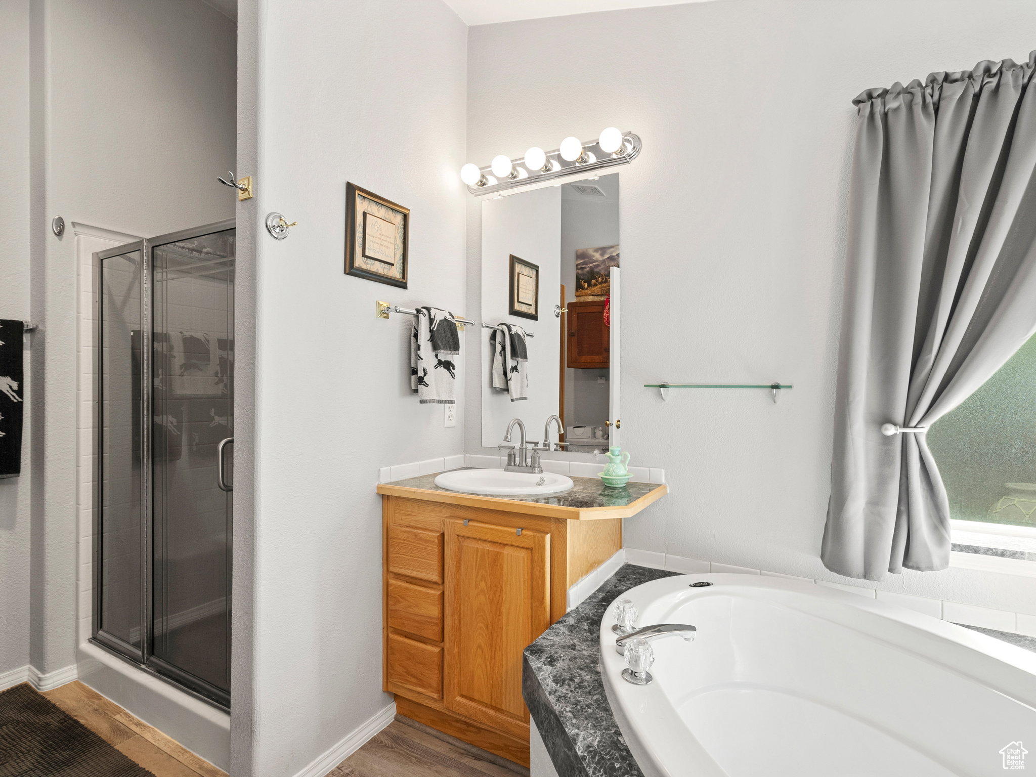 Primary bathroom with standing shower, garden tub and dual sinks.