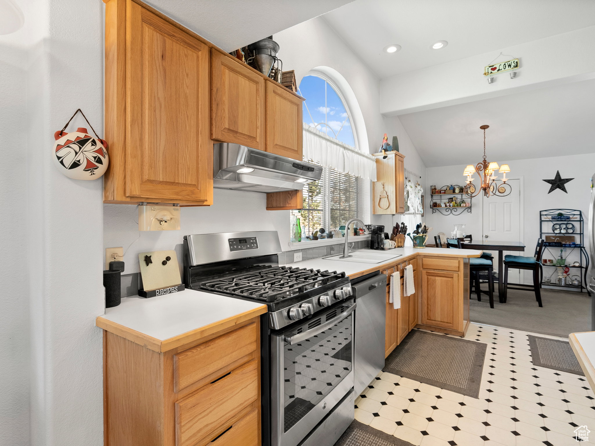 Kitchen with lots of natural light, gas stove and refrigerator included with the home.