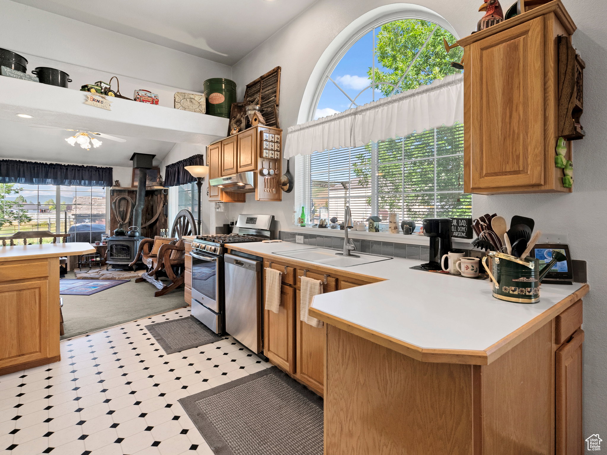 Kitchen with lots of natural light, gas stove and refrigerator included with the home.