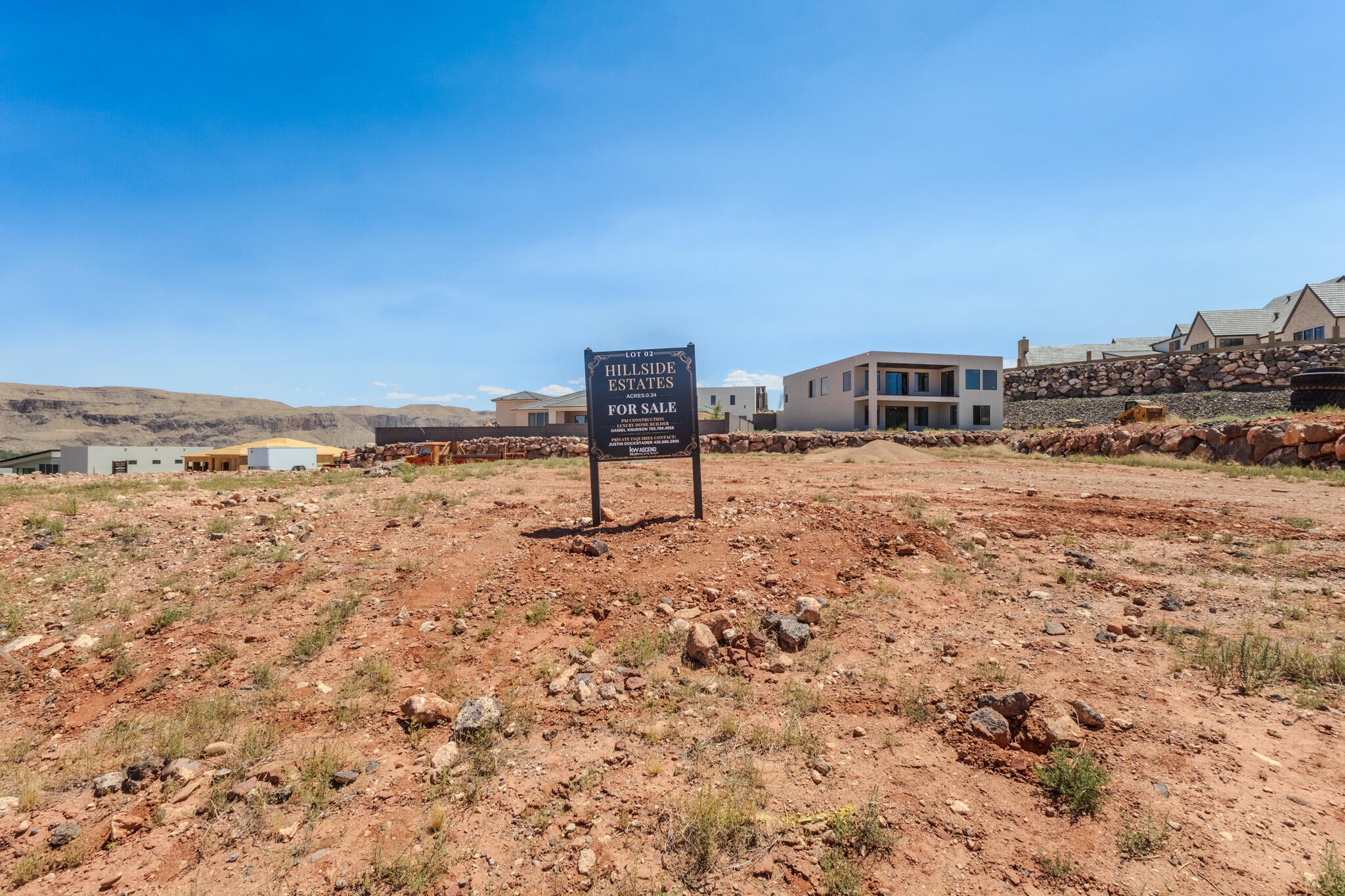 Expansive land parcel with surrounding residential development and distant mesa formations