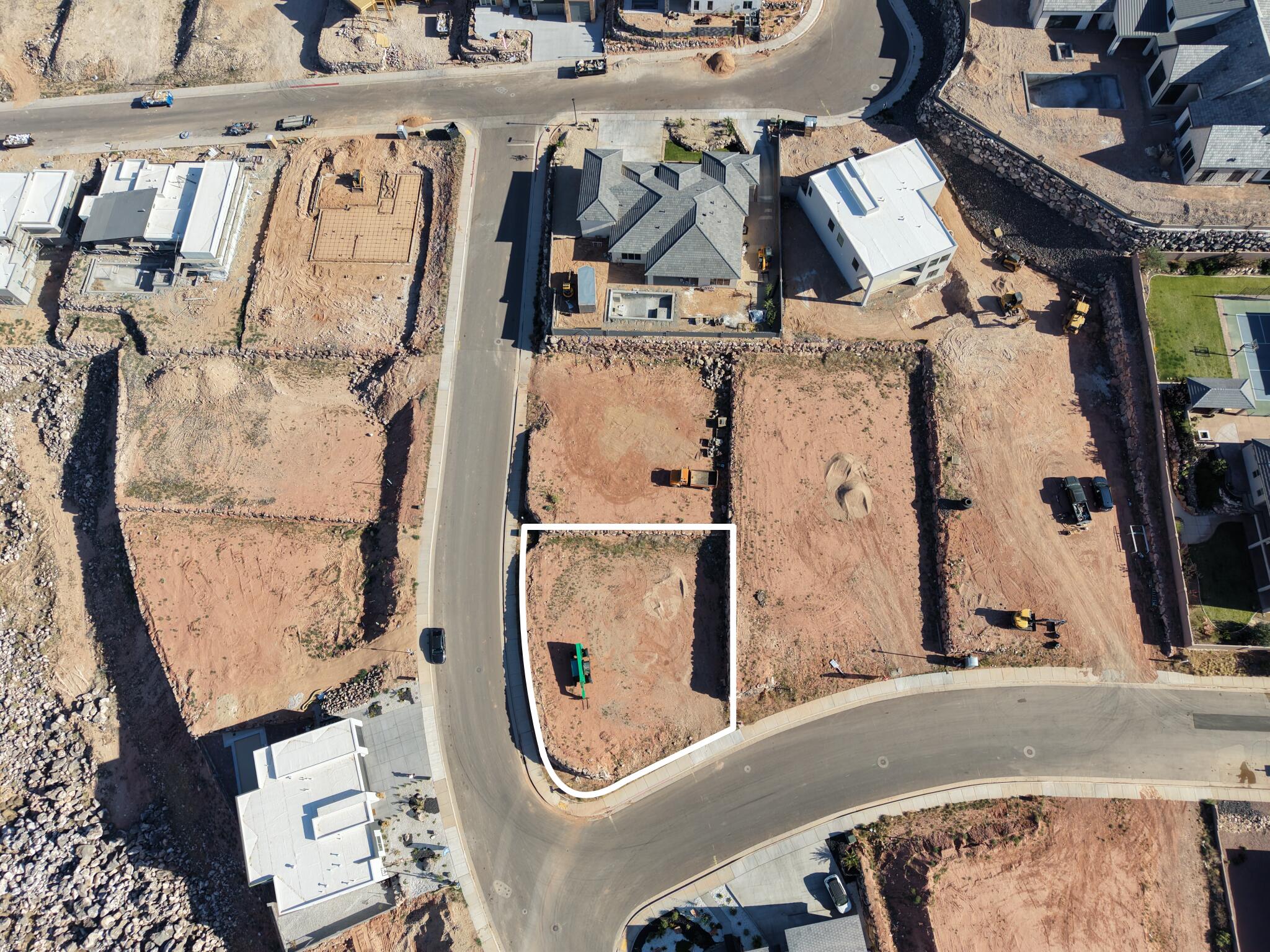 Corner lot with visible street frontage and surrounding residential structures