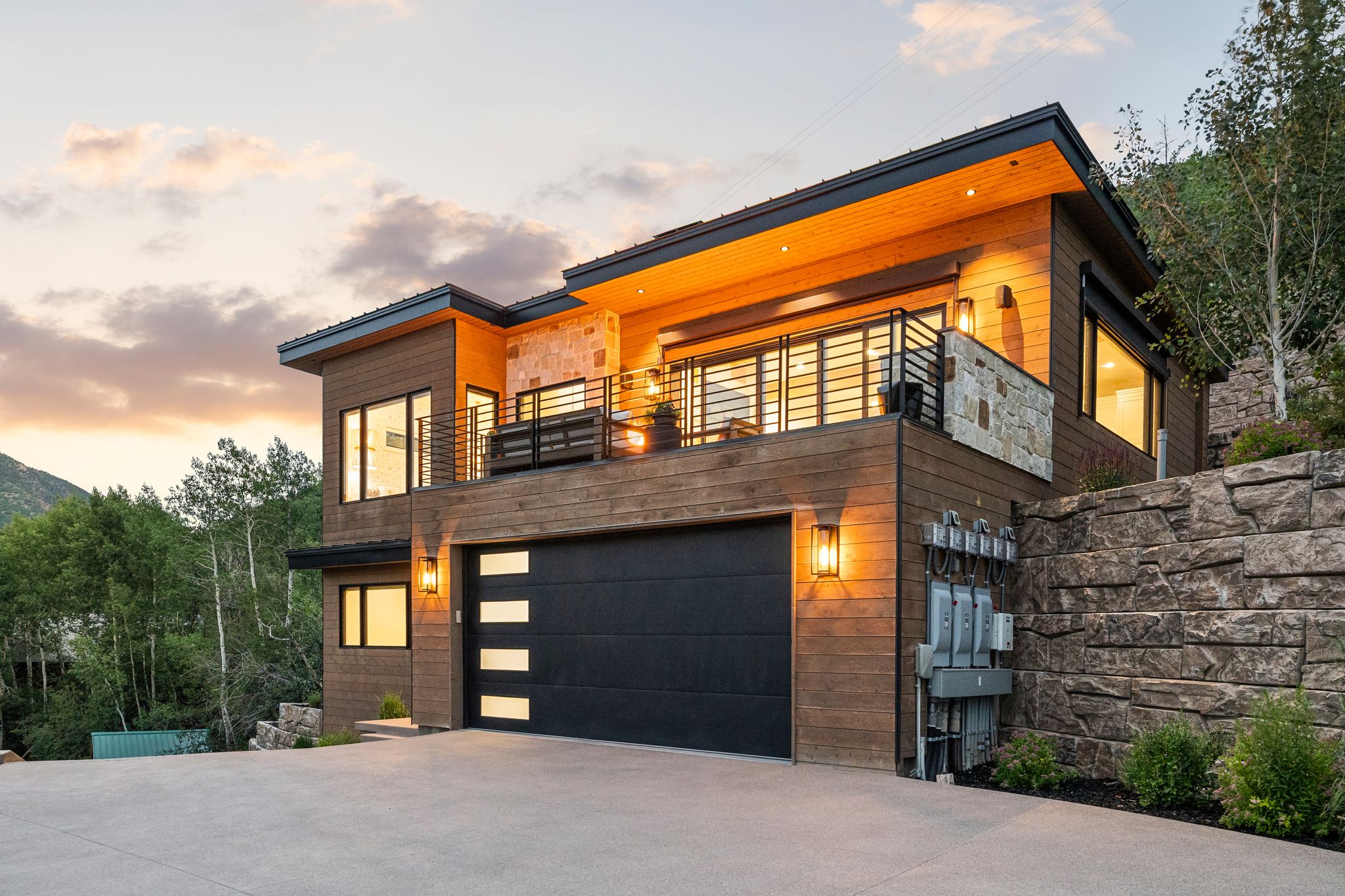 Modern facade featuring wood-finish siding and stone accents