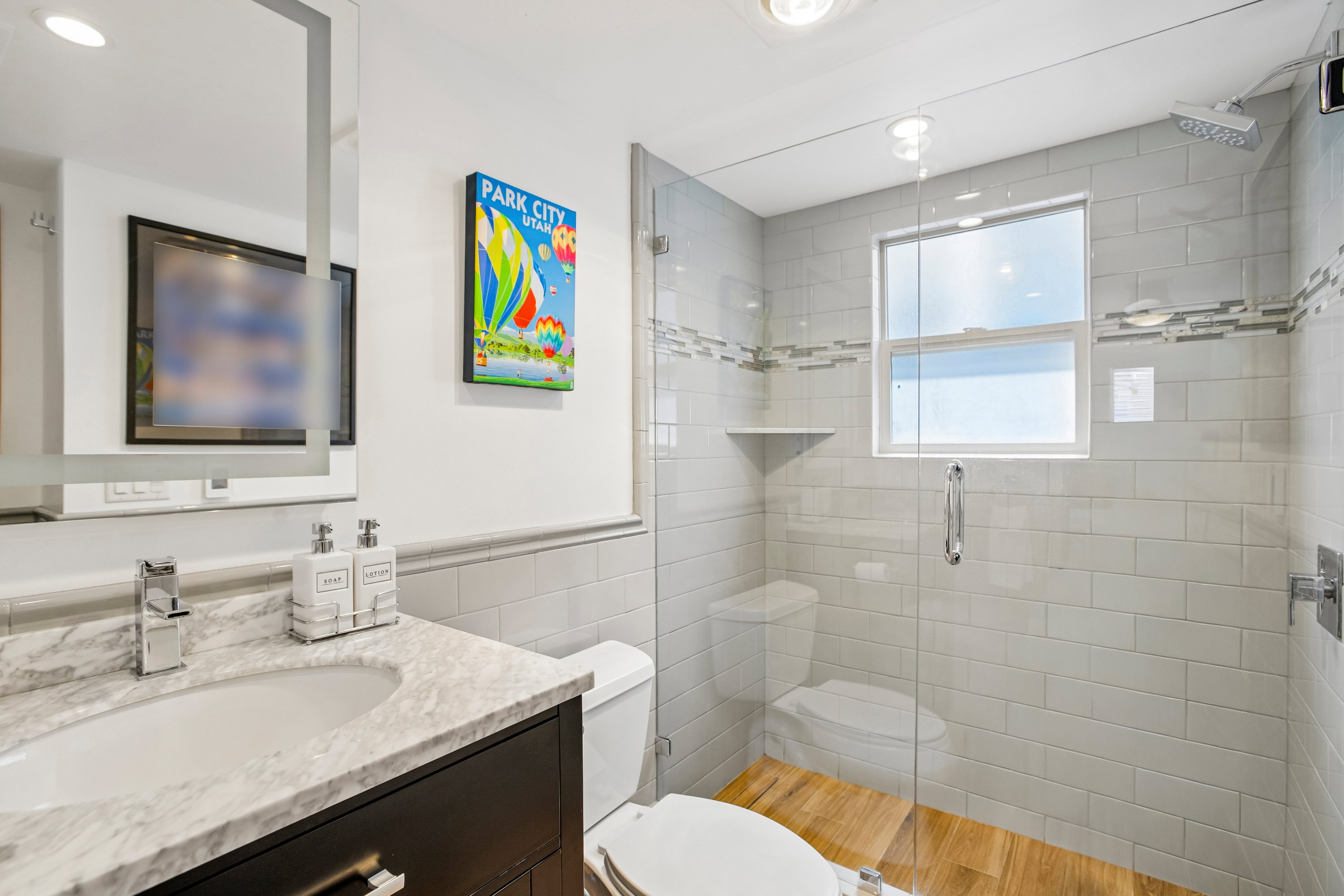 Bathroom featuring a dark wood vanity with a white marble countertop and integrated sink
