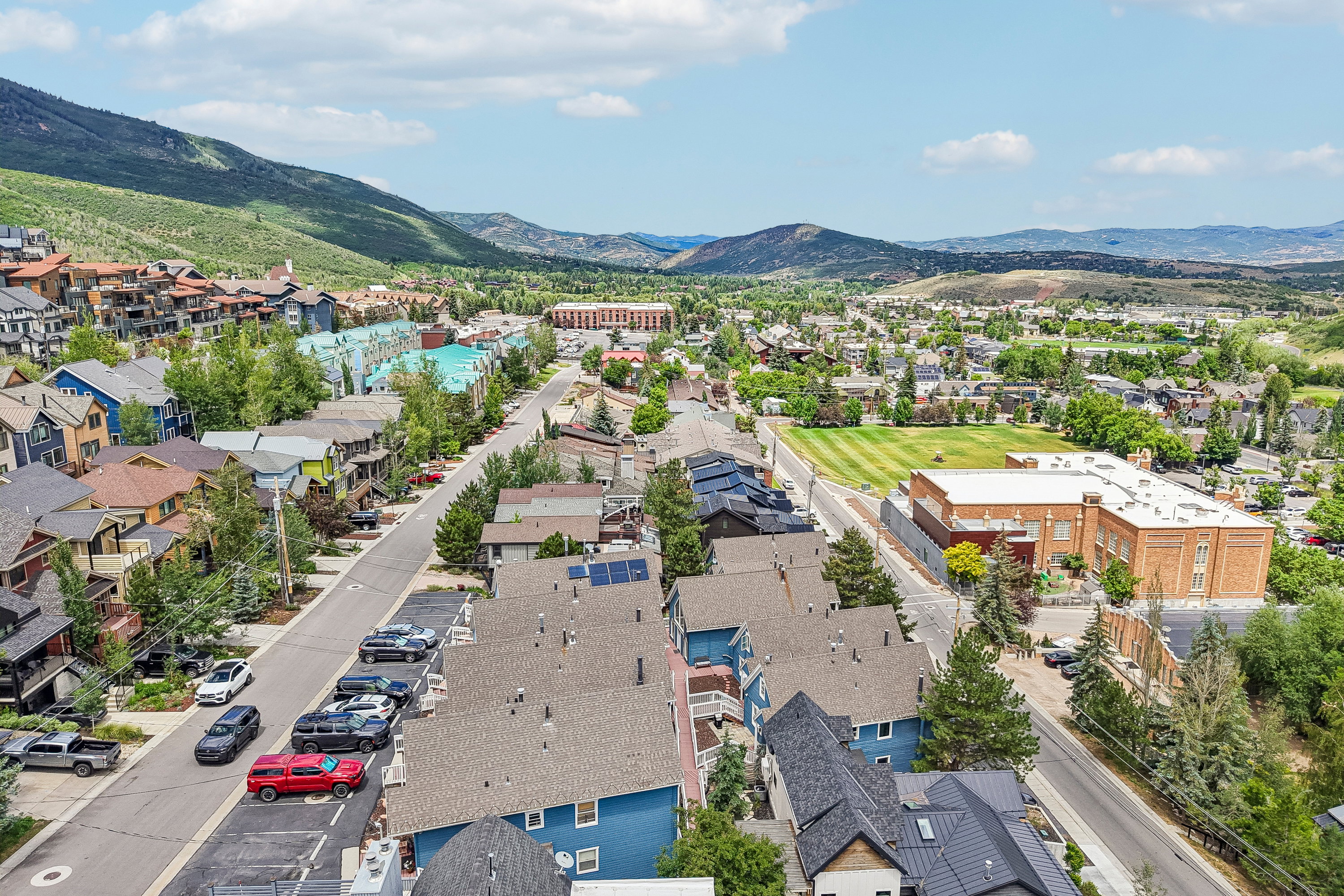 Aerial perspective of a developed mountain community with varied residential architecture