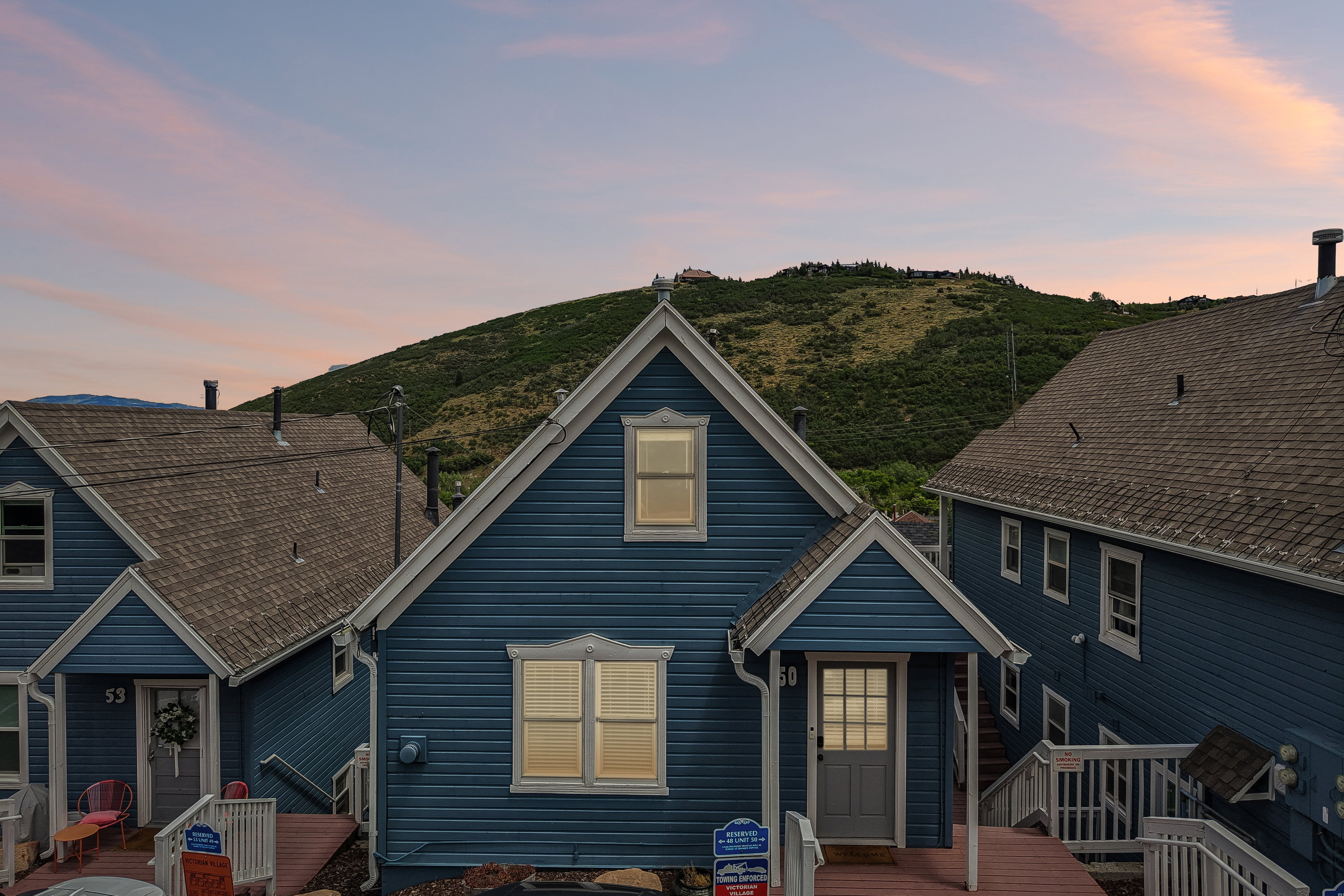 Blue siding exterior with white trim, featuring a prominent front gable