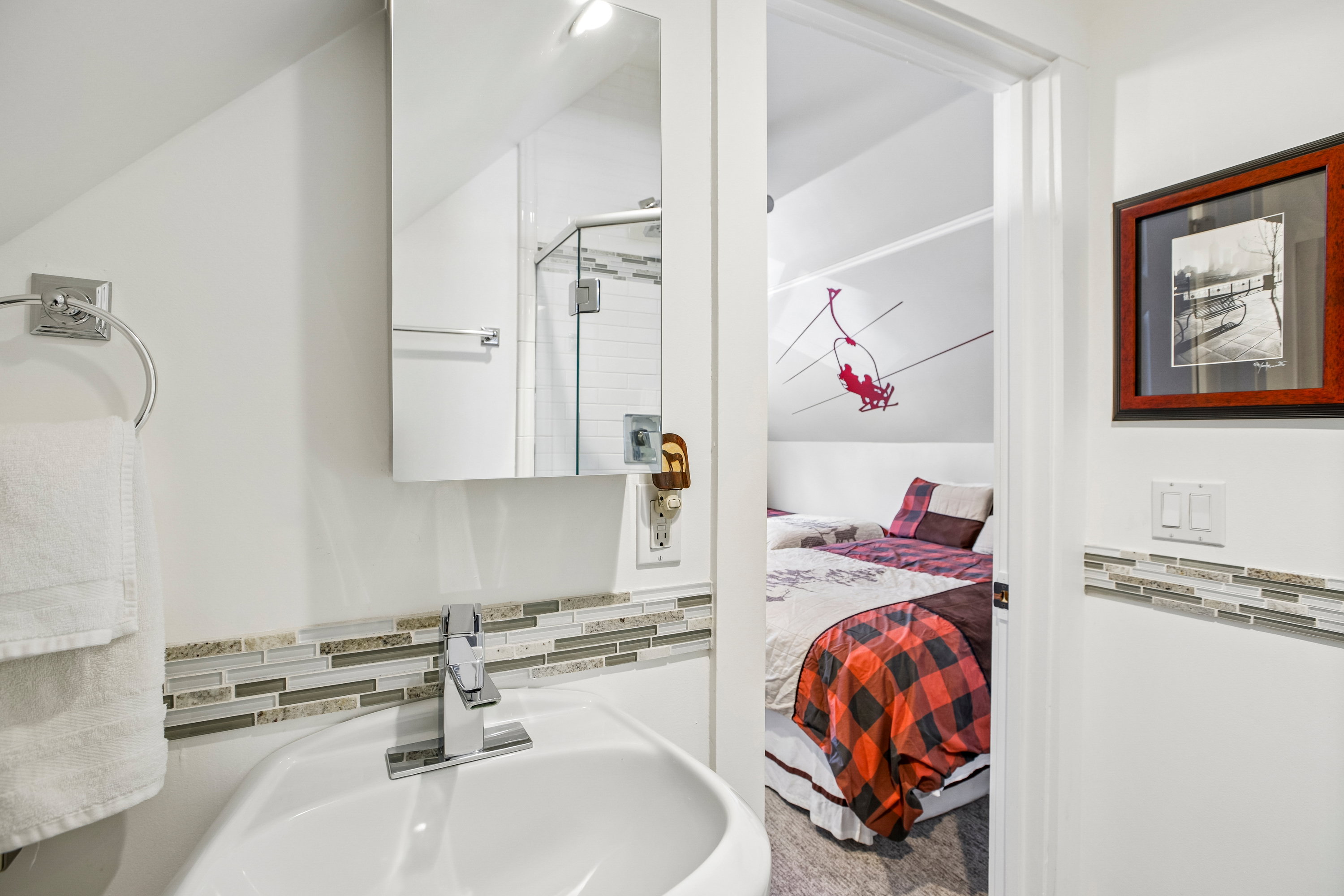 Compact bathroom featuring a white pedestal sink with a chrome faucet