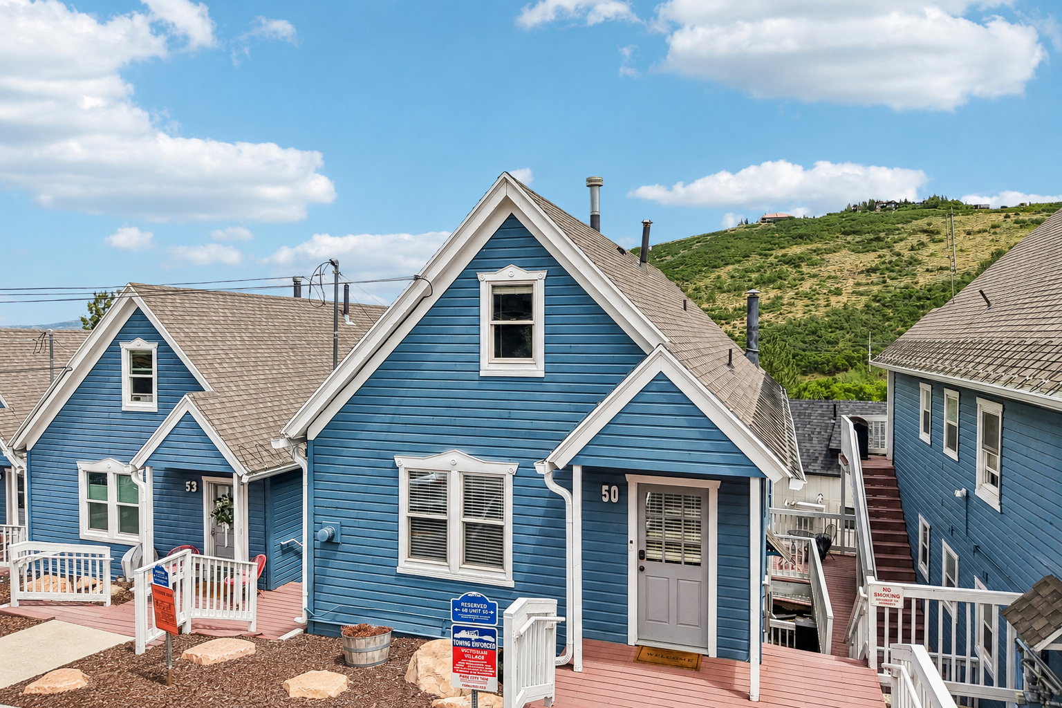 Gable-front exterior featuring blue siding and white trim