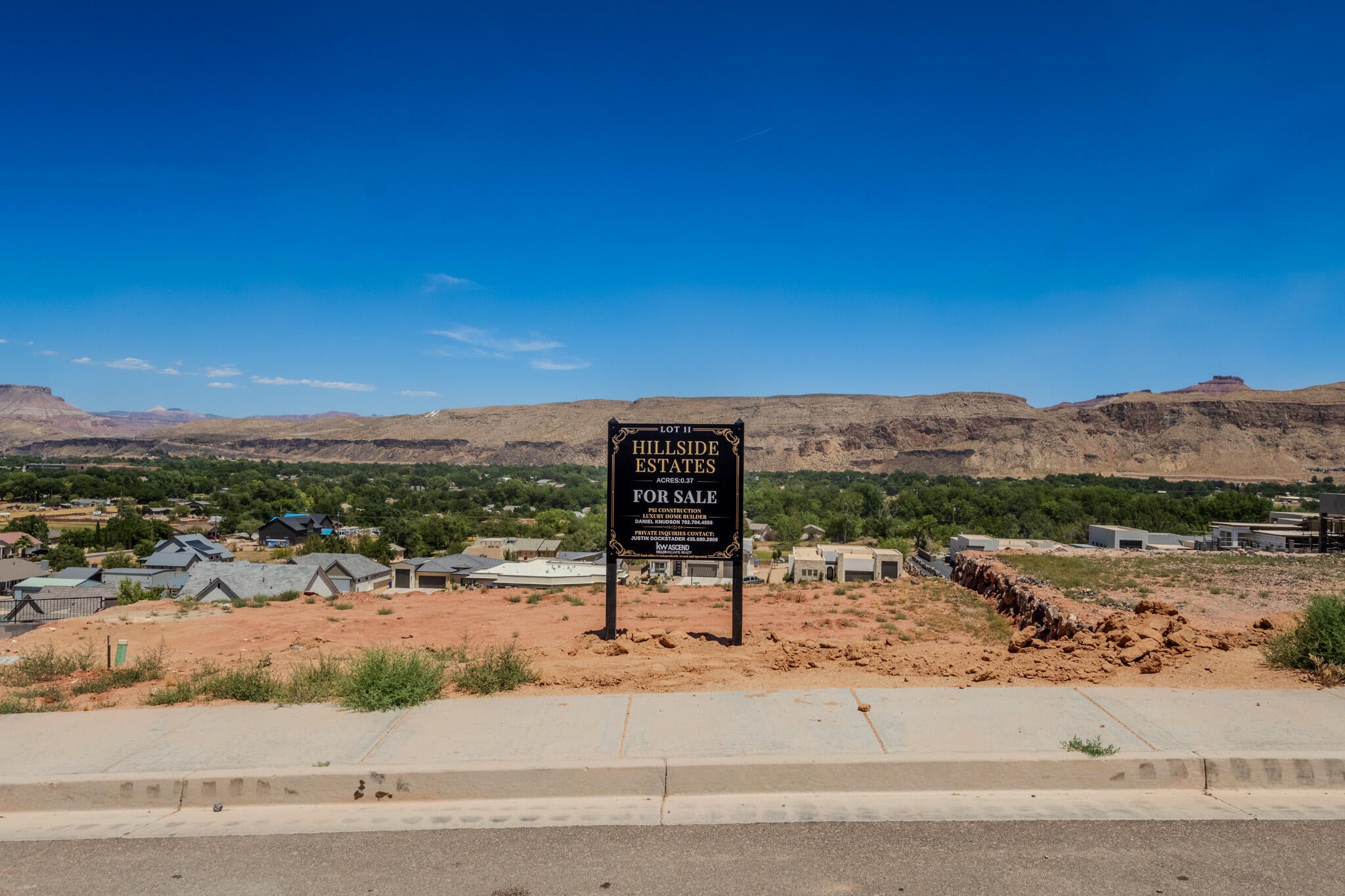 Graded building lot featuring a level street frontage and surrounding mountain scenery