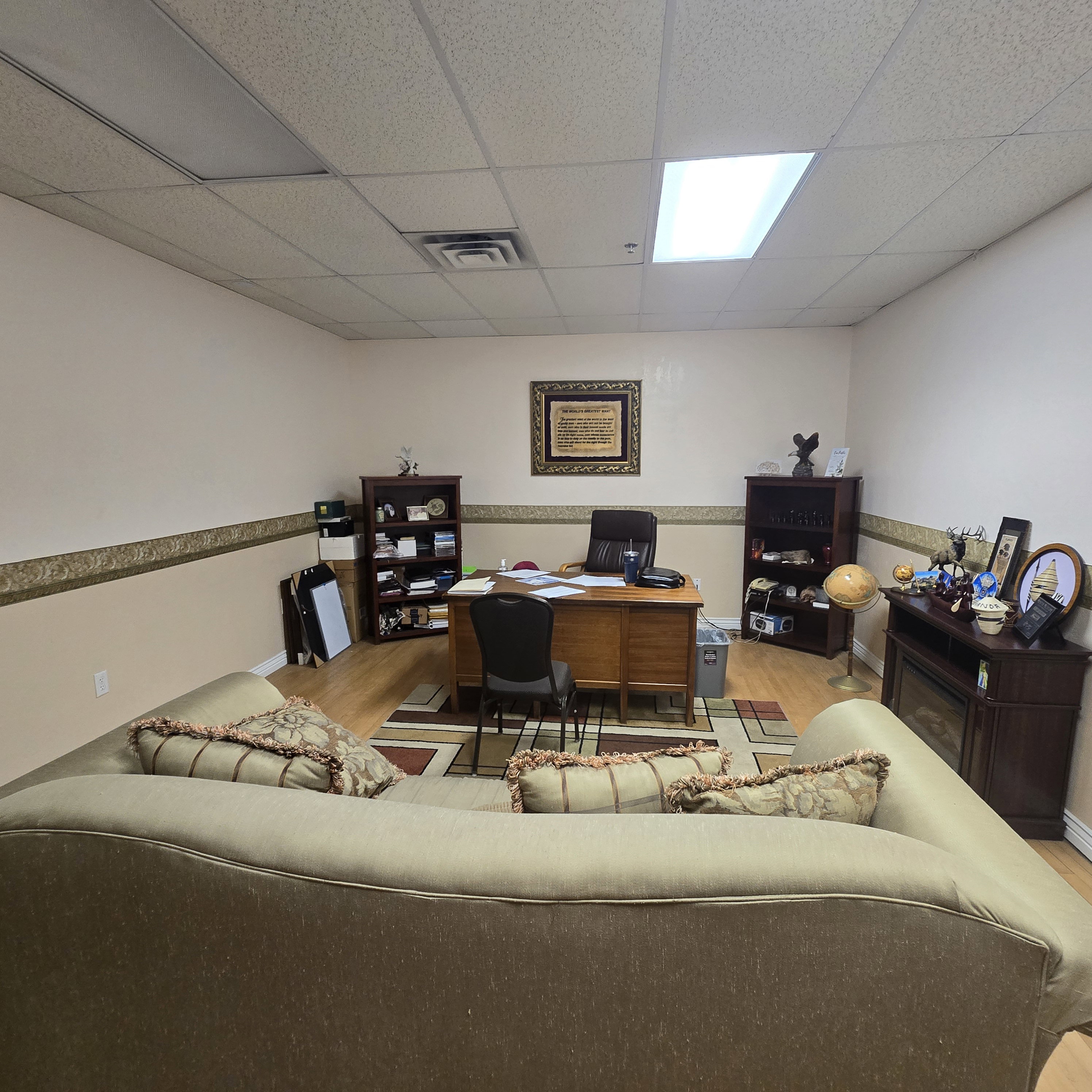Spacious room with a drop ceiling featuring recessed lighting