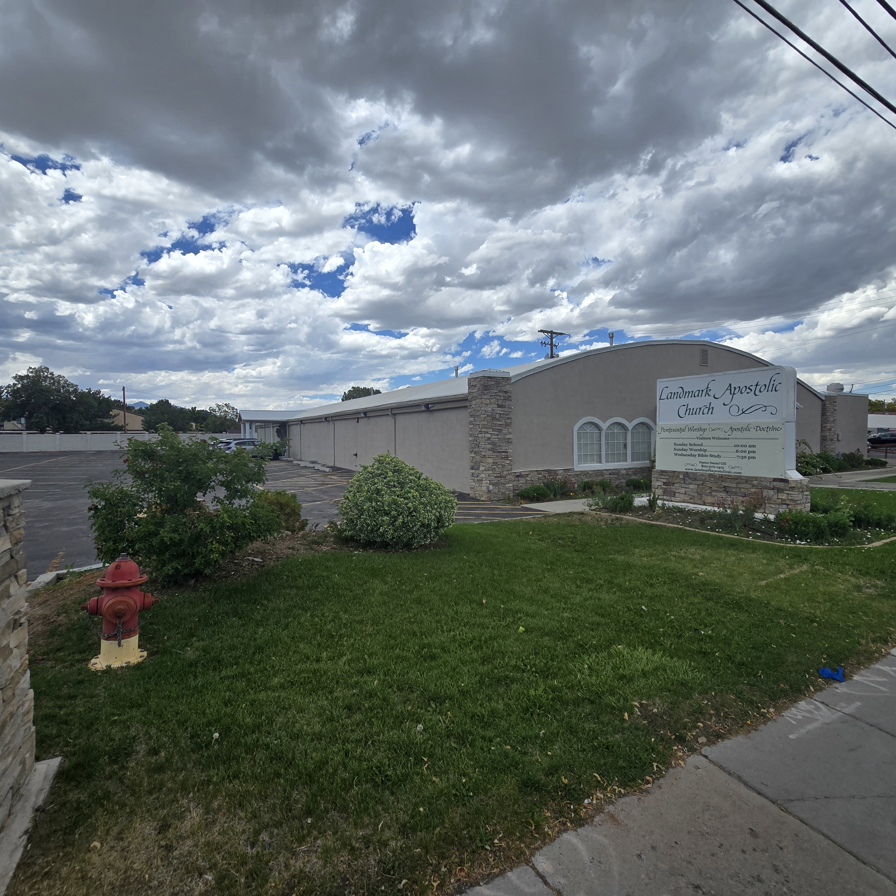 Commercial building featuring a stucco exterior with stone accents and arched windows