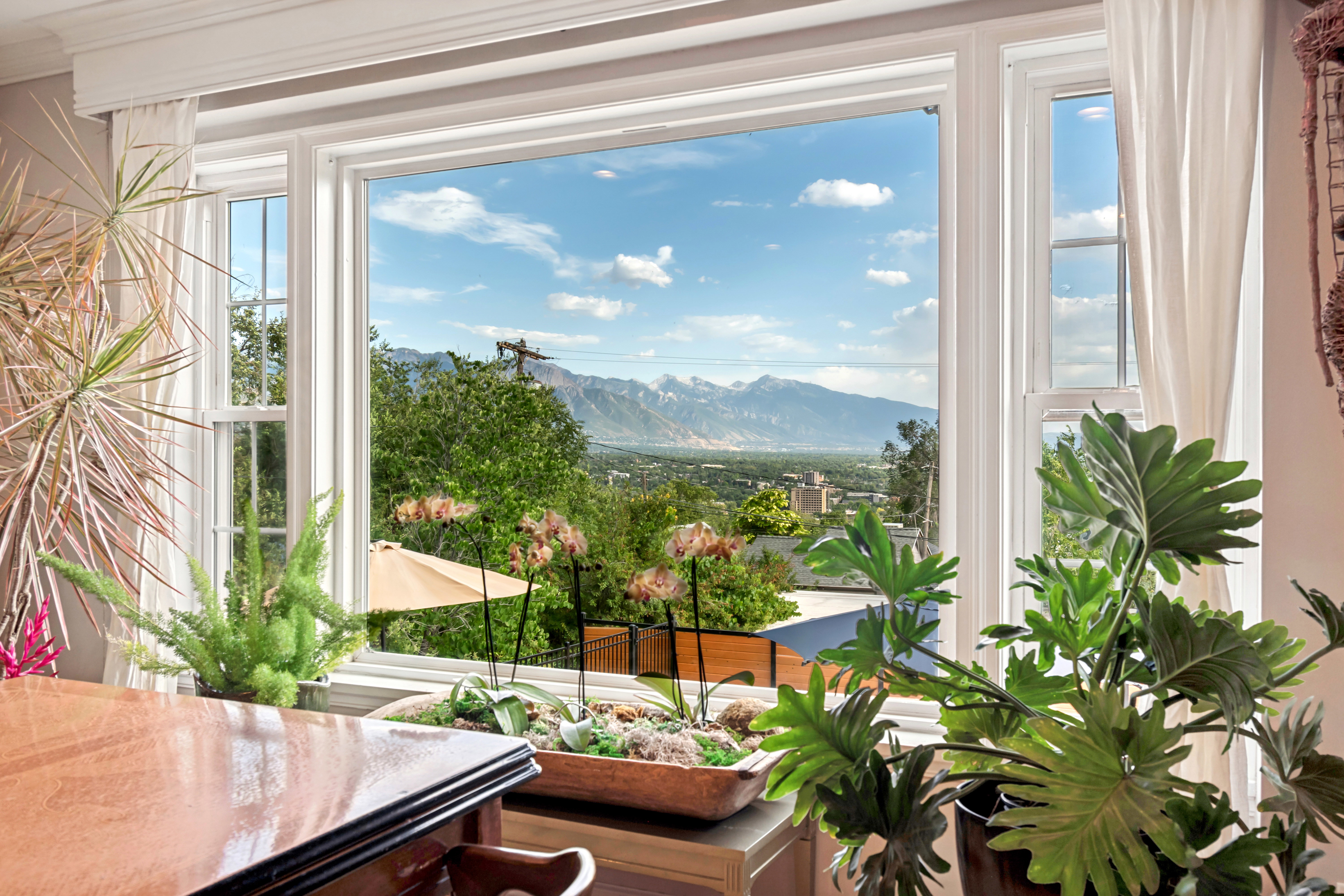 Expansive picture windows offering mountain and cityscape scenery