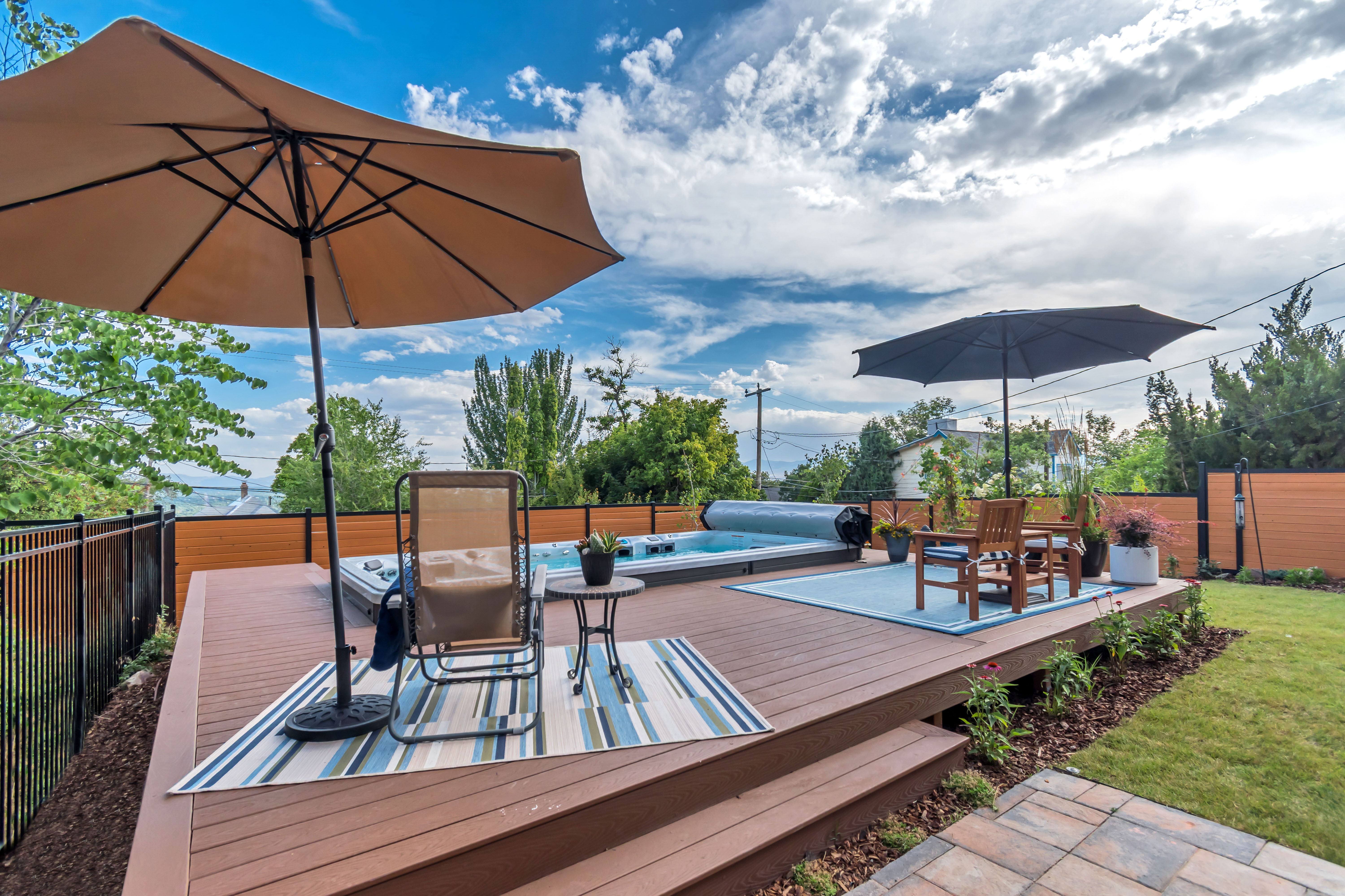 Spacious multi-level deck featuring a built-in hot tub