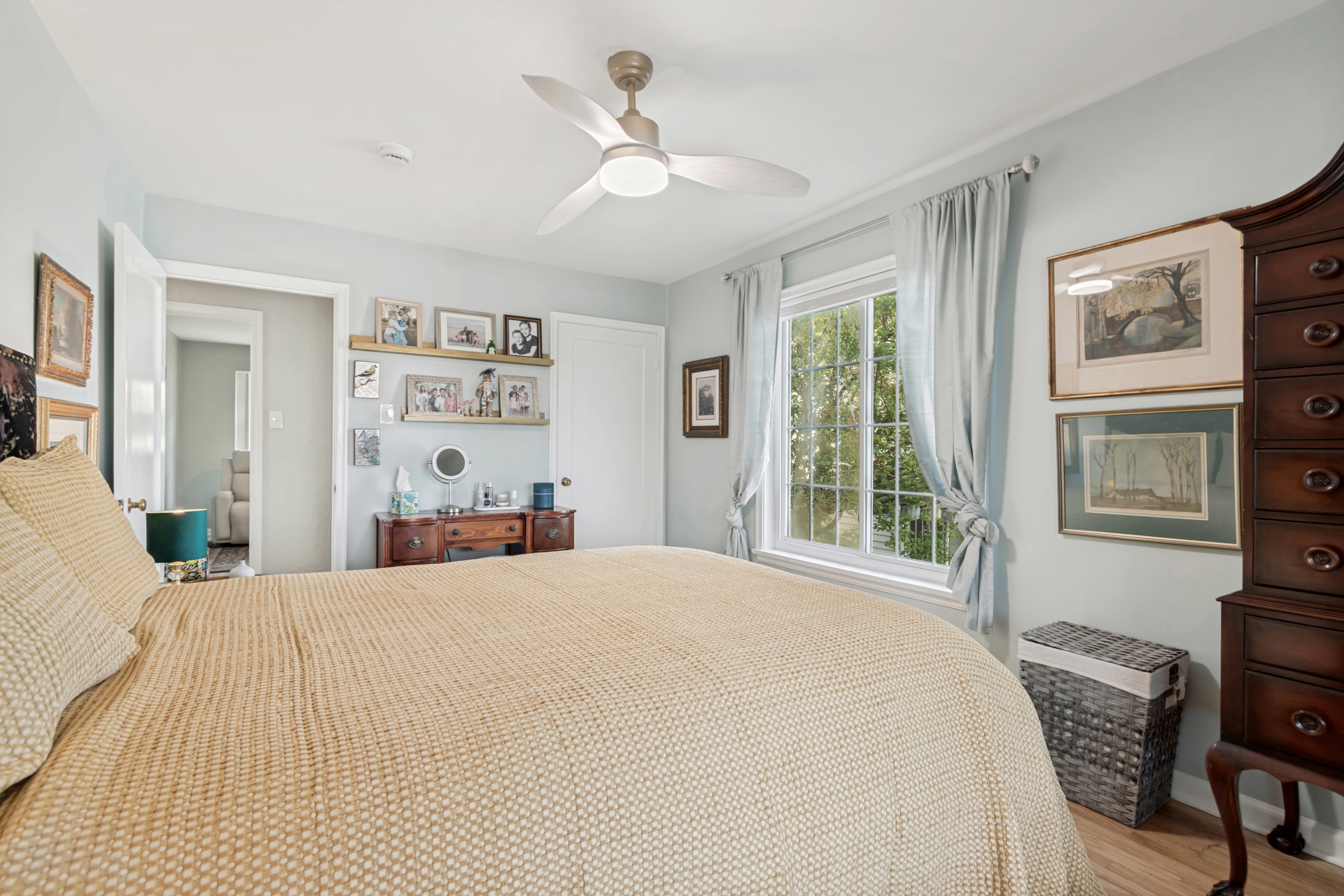 Bedroom featuring light-colored walls and wood-finish flooring