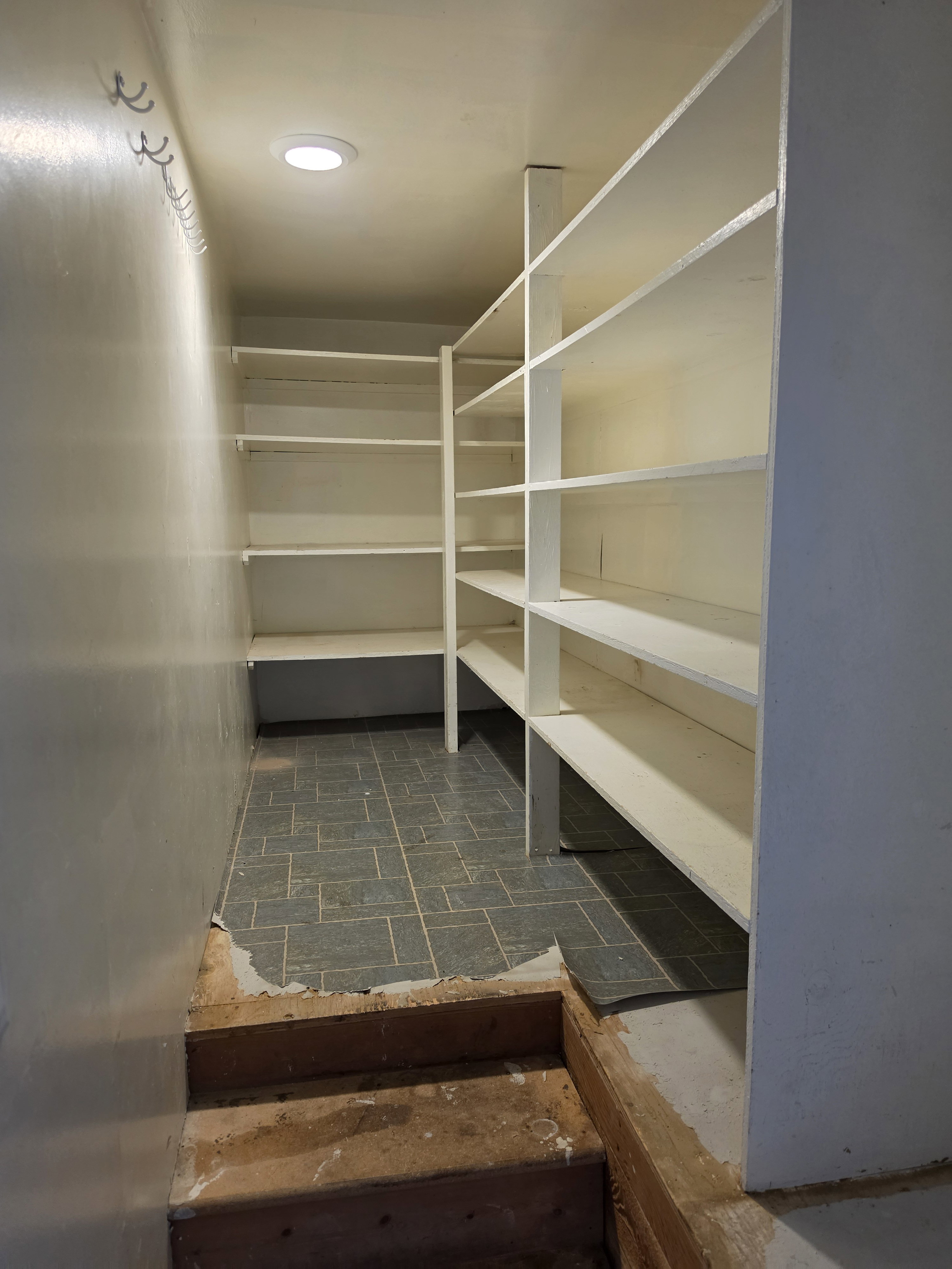 Built-in shelving storage with recessed ceiling lighting and tile flooring