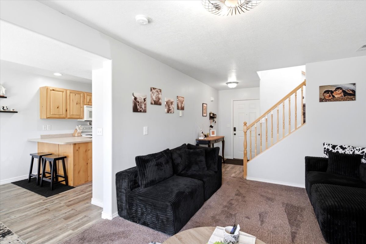 Living area featuring a light gray wall color and brown carpet flooring