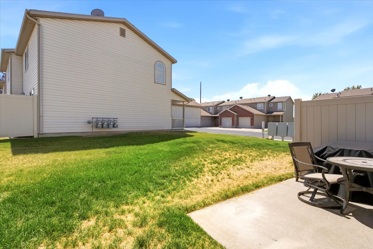 Expansive lawn area with a concrete patio