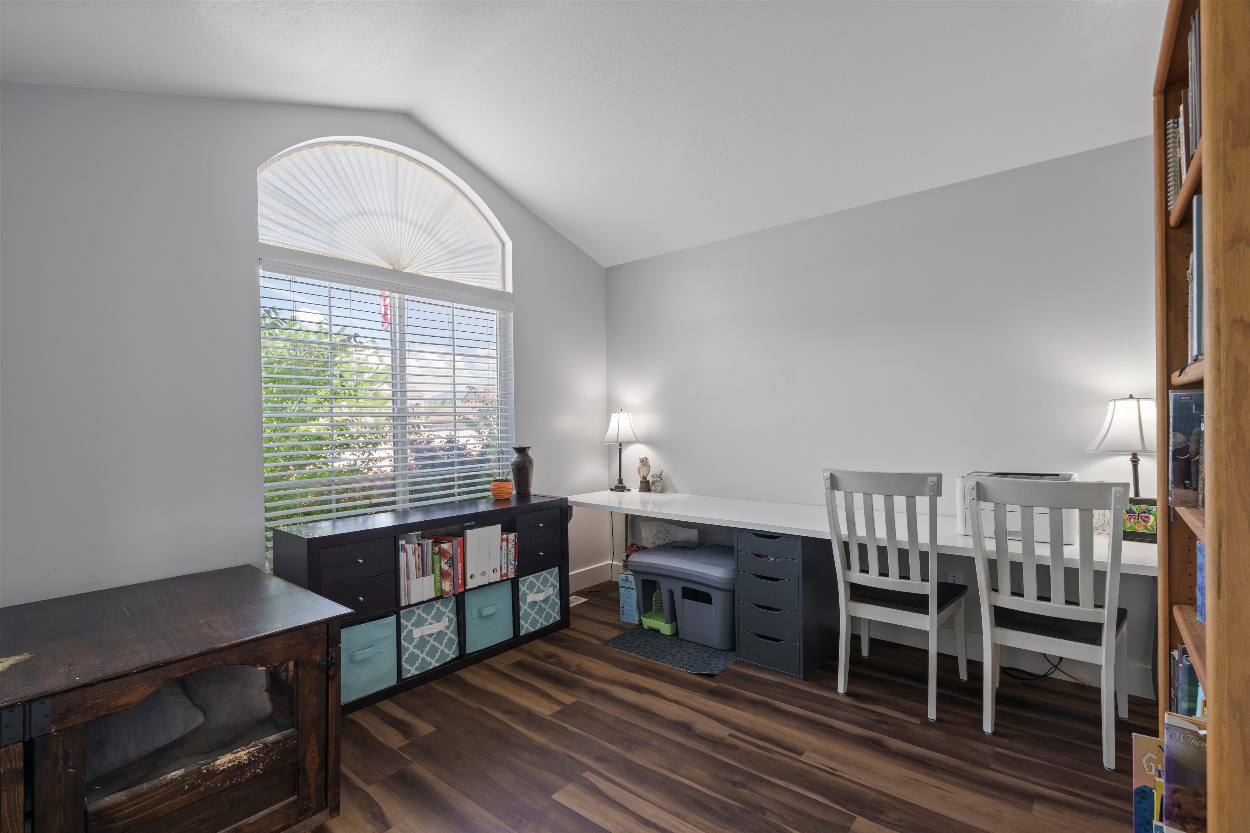 Arch-top window with blinds and vaulted ceiling