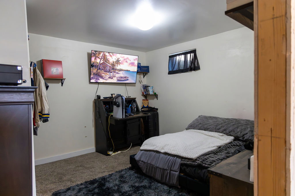 Carpeted room with white walls, a single window, and a flush-mount ceiling light fixture