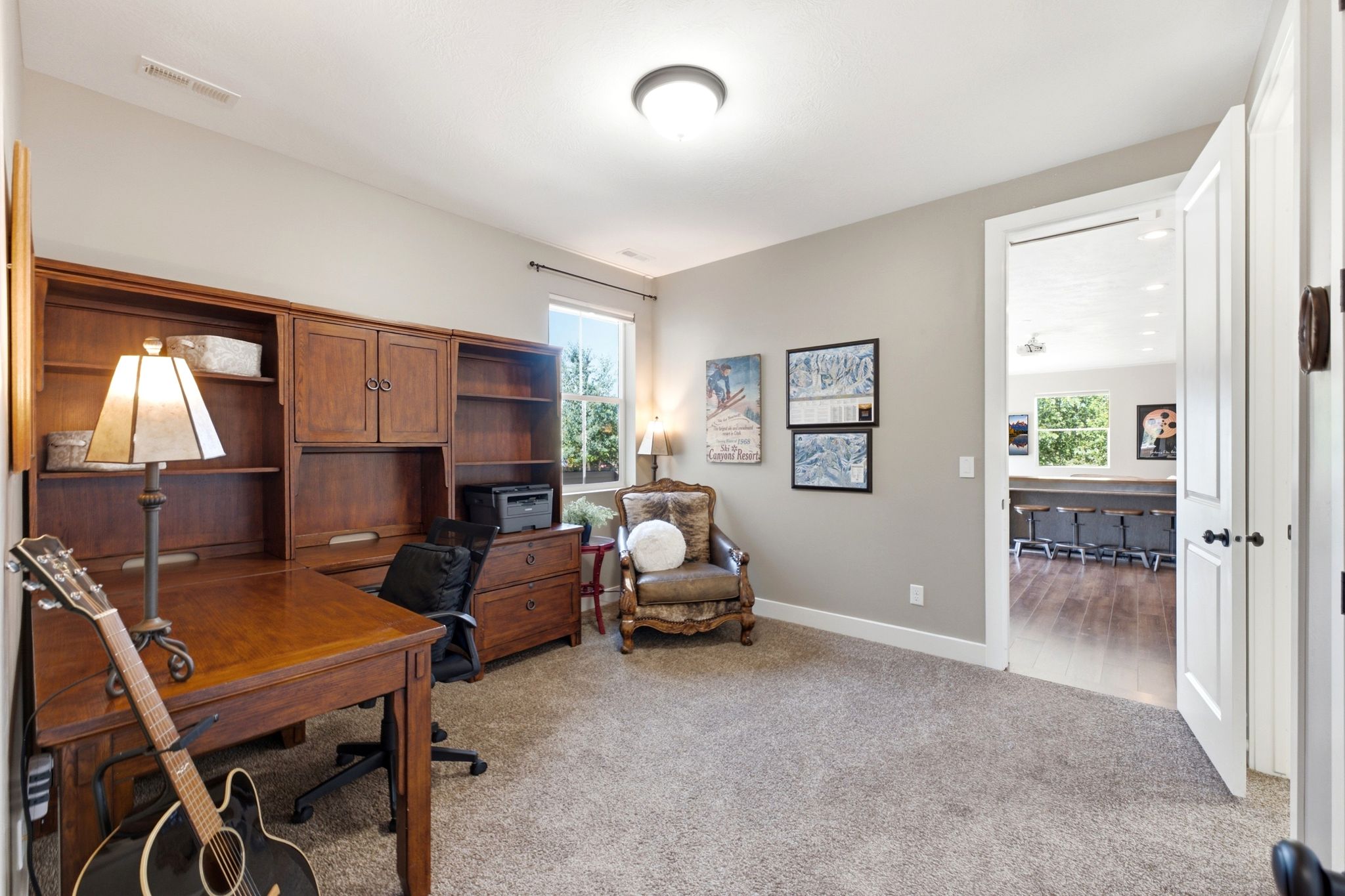 Built-in wood-finish shelving and desk unit with cabinet storage