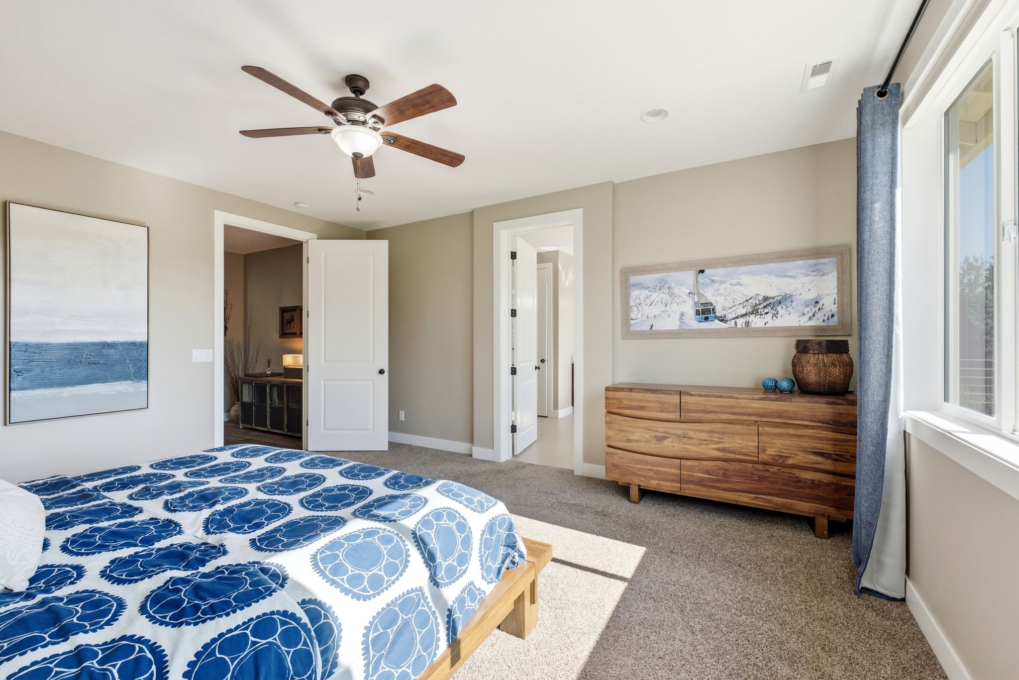 Carpeted interior room featuring a ceiling fan with integrated lighting, recessed lighting, and a large window with natural light