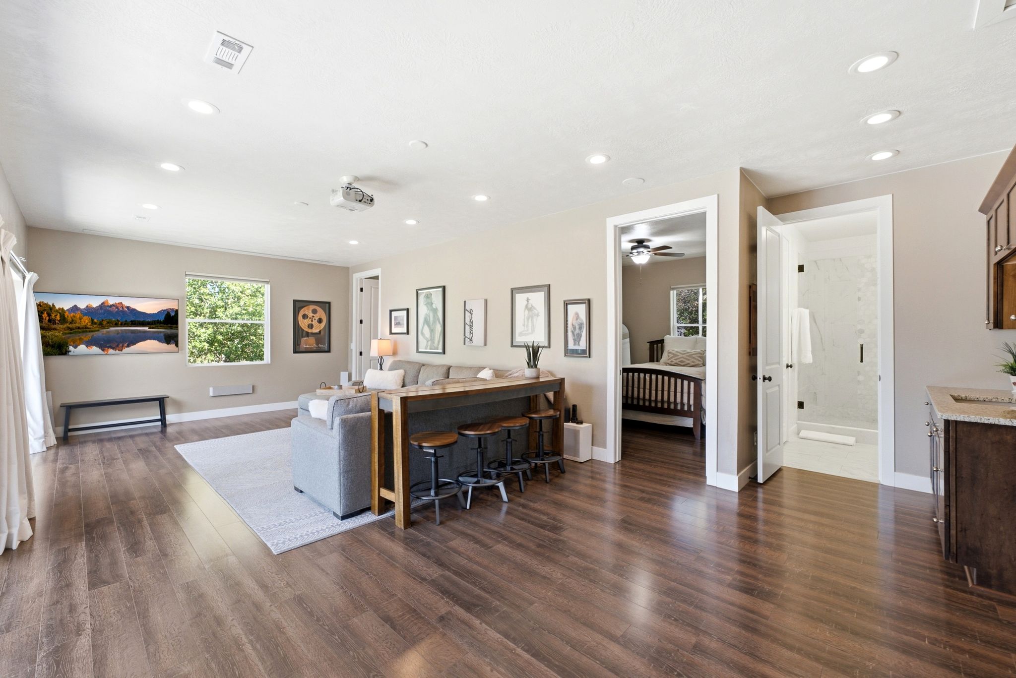 Open living area featuring wood-finish flooring, recessed lighting, and a neutral color palette