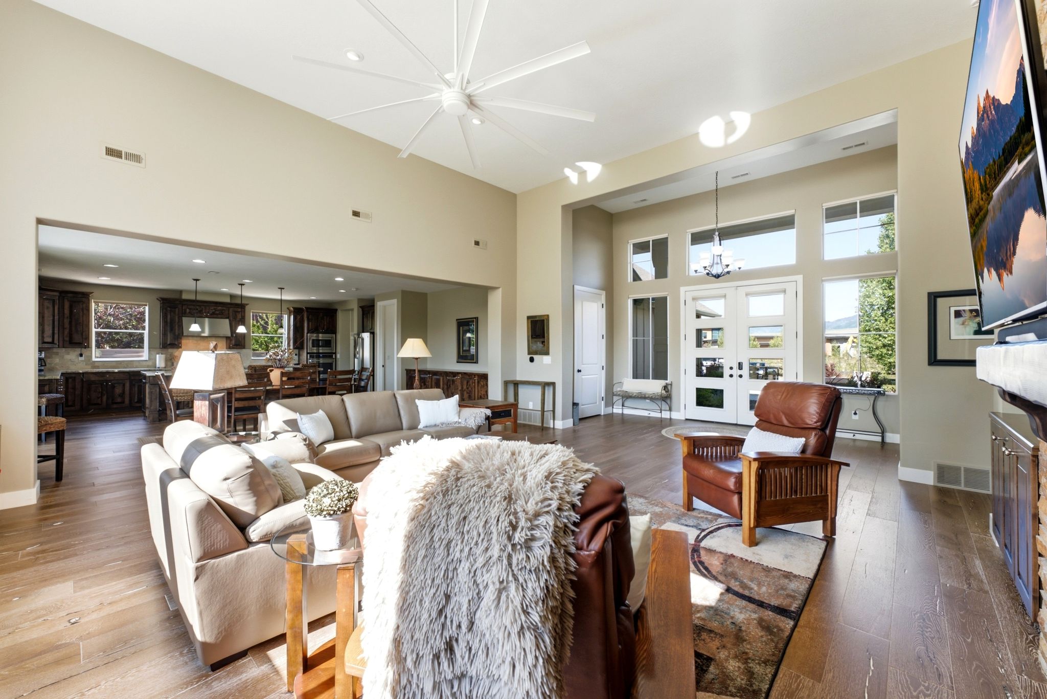 Spacious living area featuring high ceilings, wood-finish flooring, and an open concept layout
