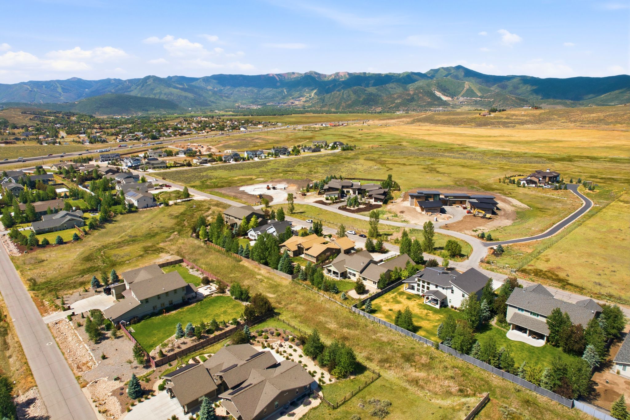 Expansive residential area featuring established homes, undeveloped lots, and mountain scenery