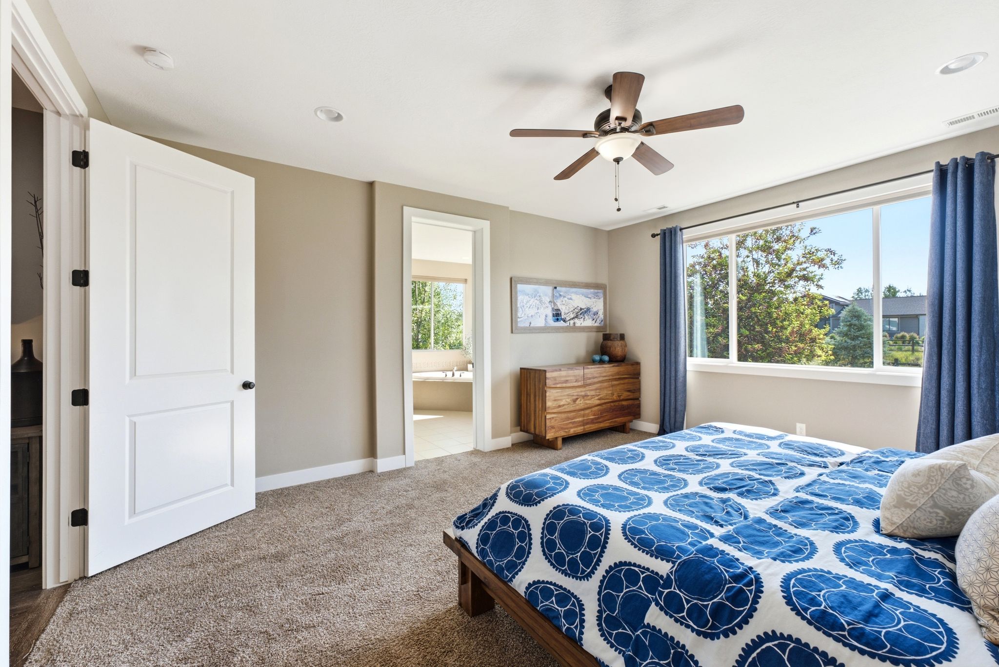 Carpeted room featuring a ceiling fan with light fixture, recessed lighting, and a window with exterior views