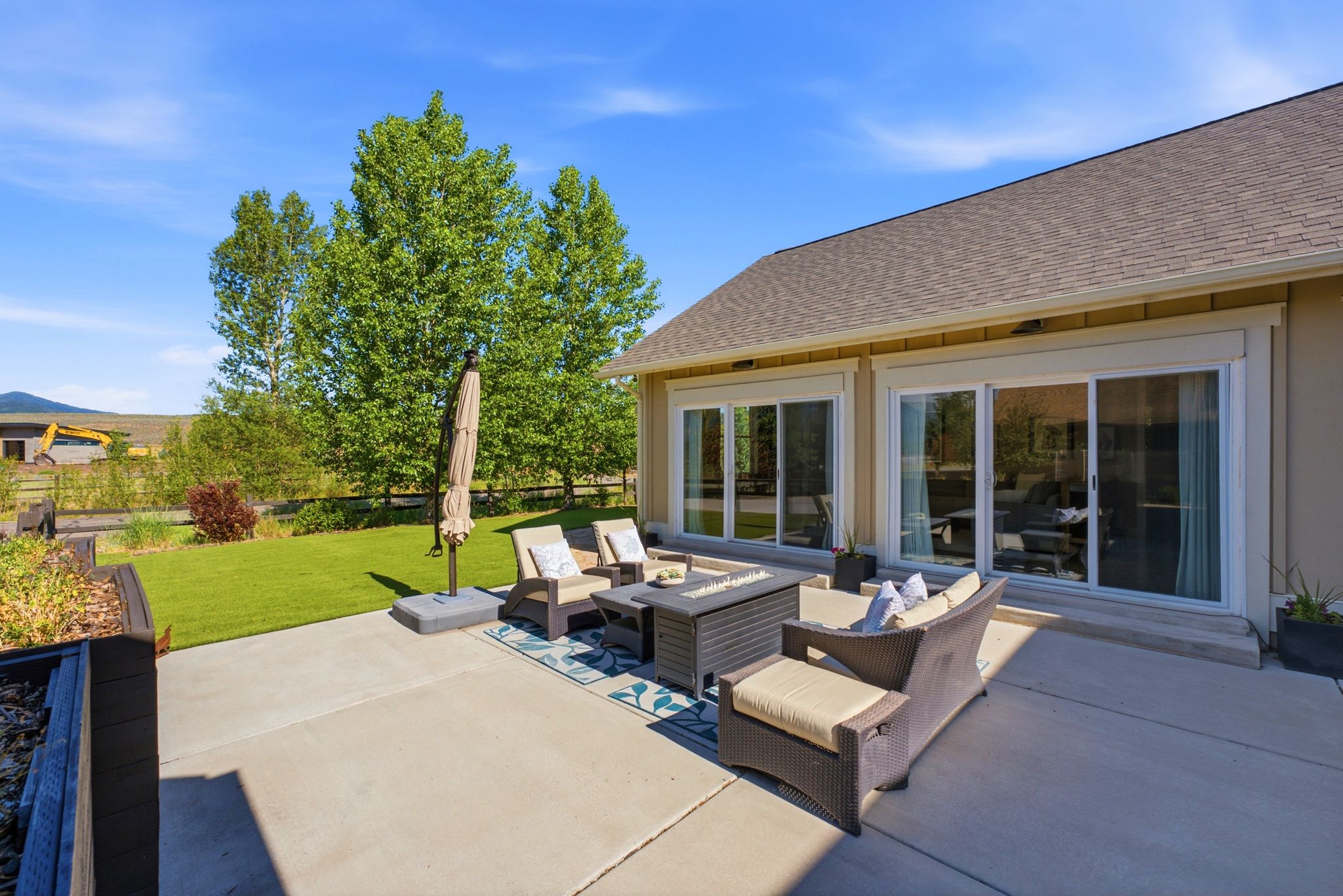 Spacious concrete patio with direct access to interior spaces through multiple sliding glass doors