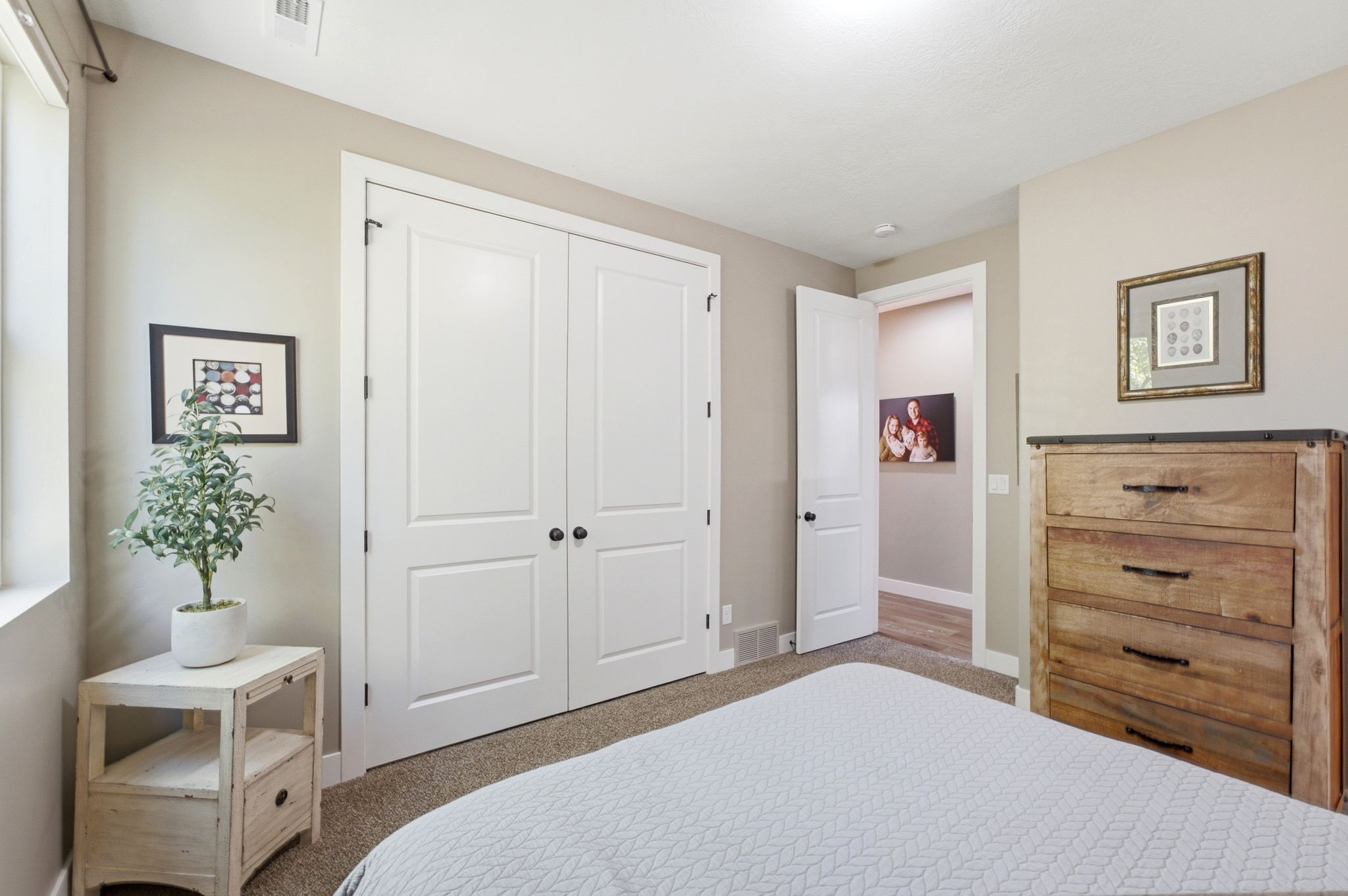 Bedroom featuring a window, neutral-toned walls, and a recessed ceiling light