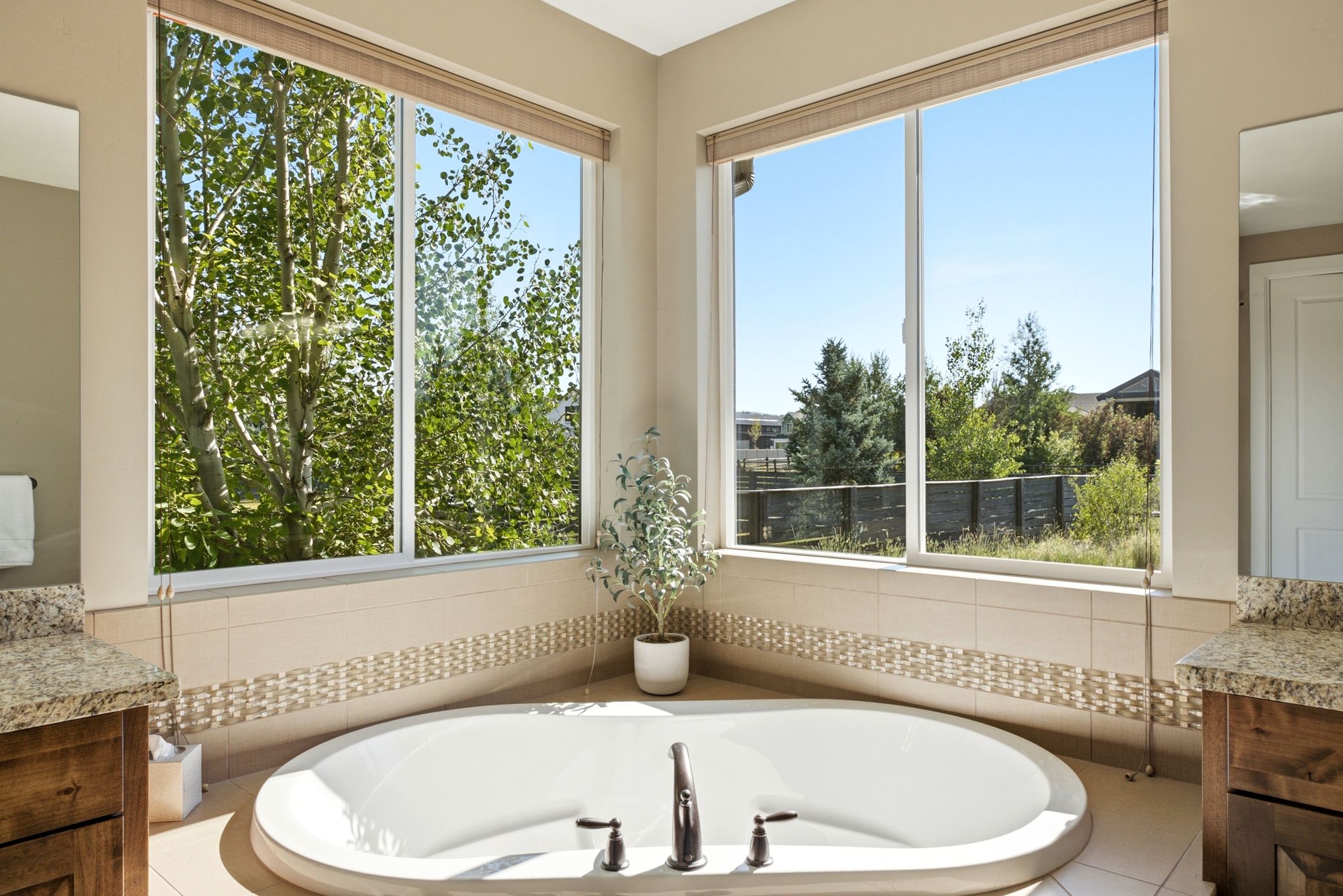 Built-in oval soaking tub with dark bronze fixtures