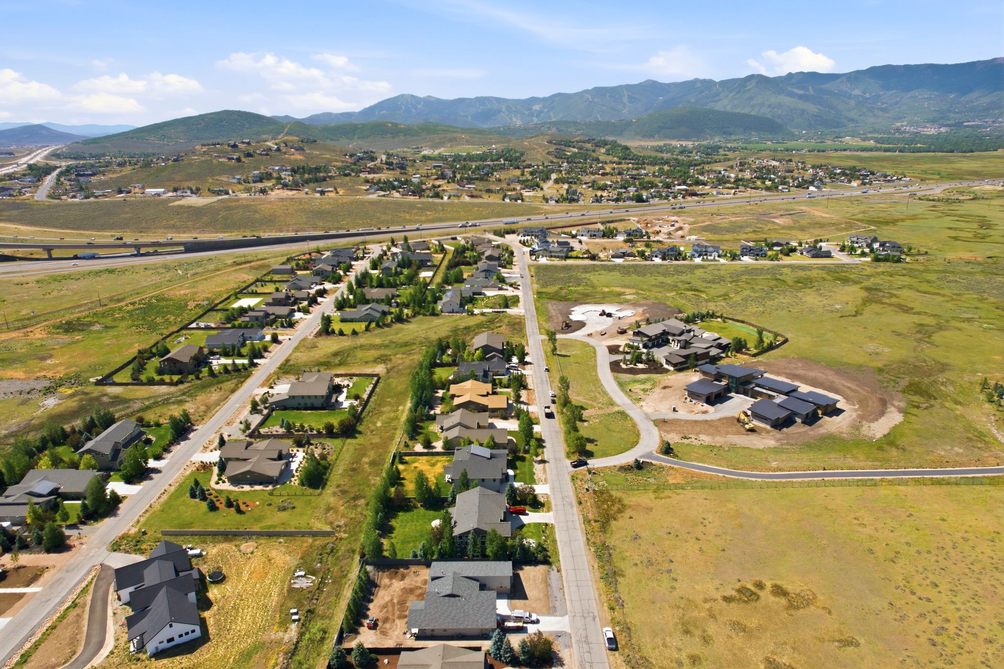 Aerial perspective showcasing a residential community with established homes and new construction