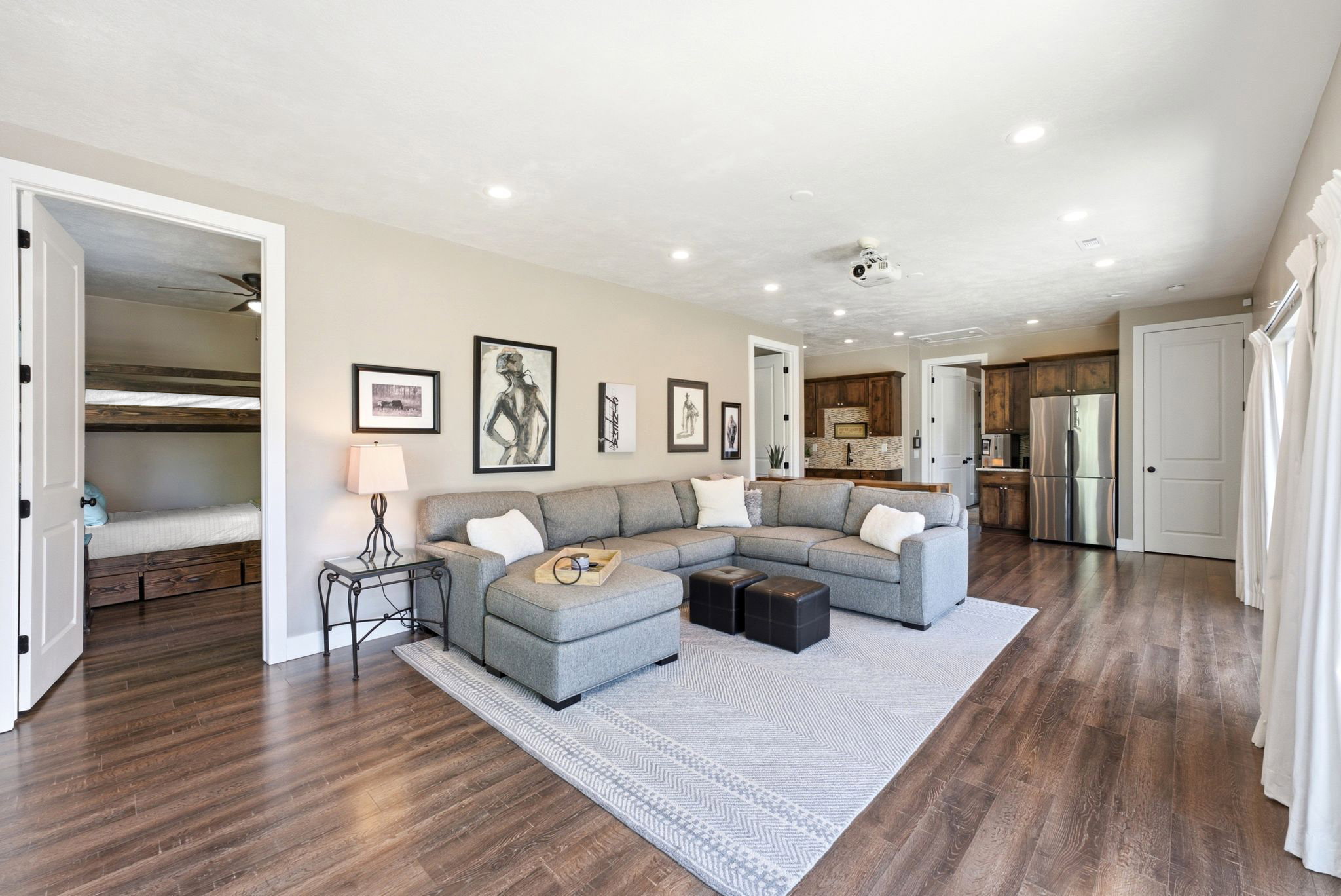 Spacious living area featuring wood-finish flooring, recessed lighting, and a neutral wall palette