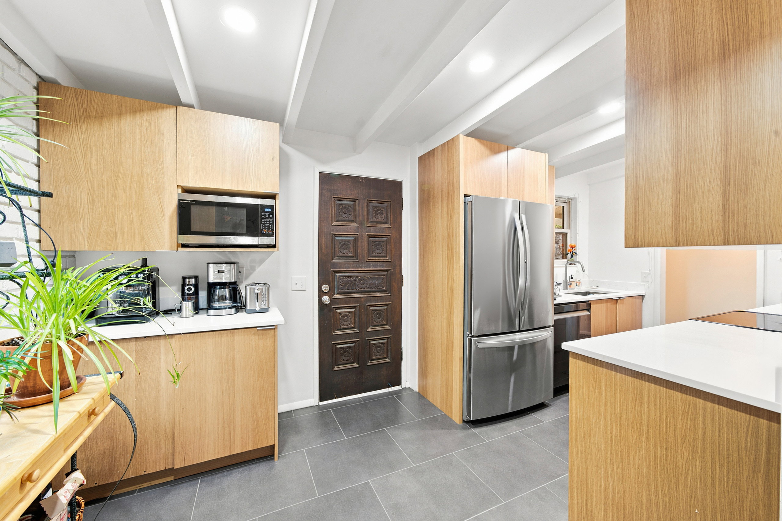 Kitchen featuring light wood-finish cabinetry, stainless steel appliances, white countertops, and recessed lighting
