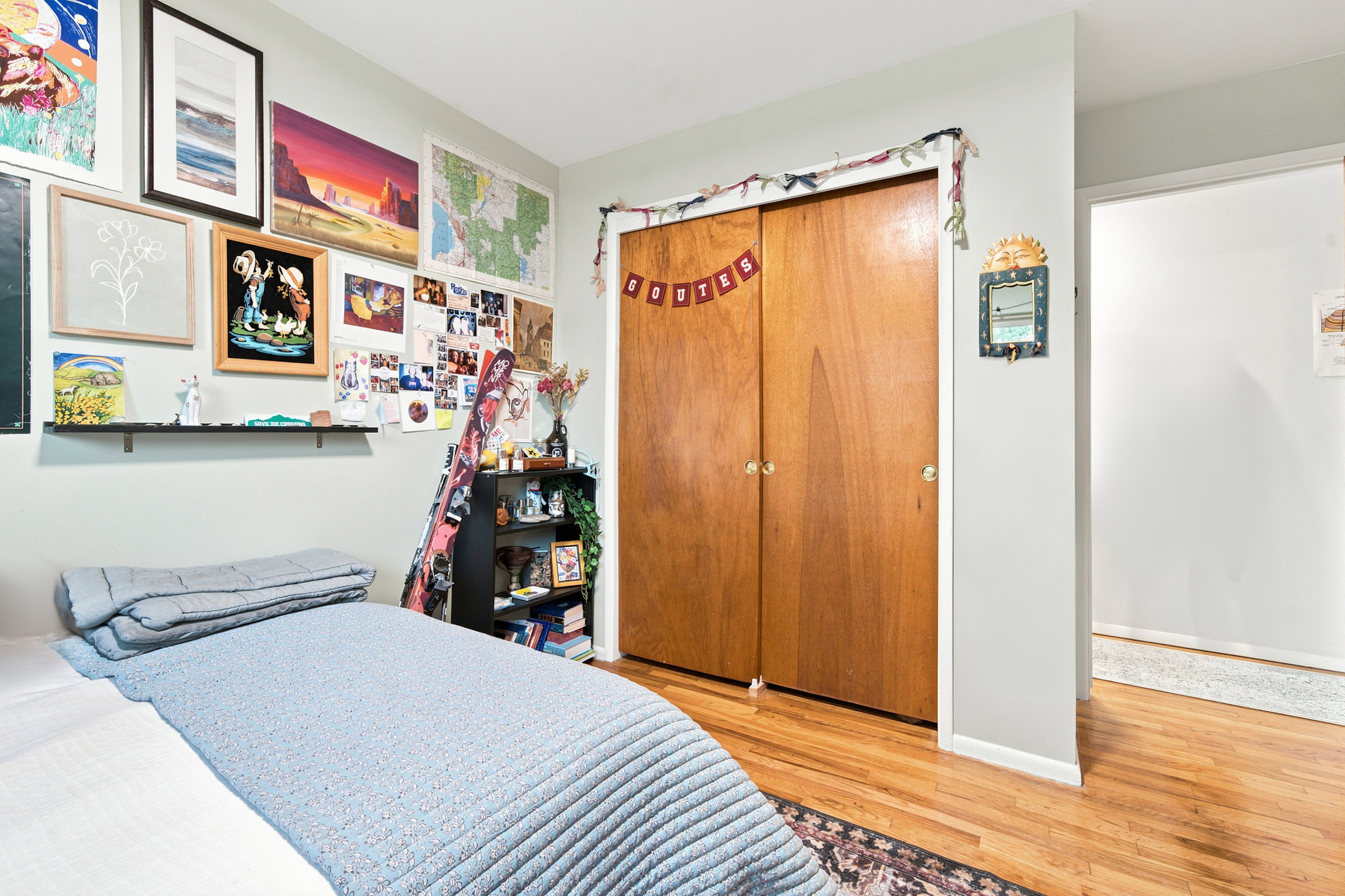 Hardwood-style flooring extends throughout this room, complemented by light-colored walls