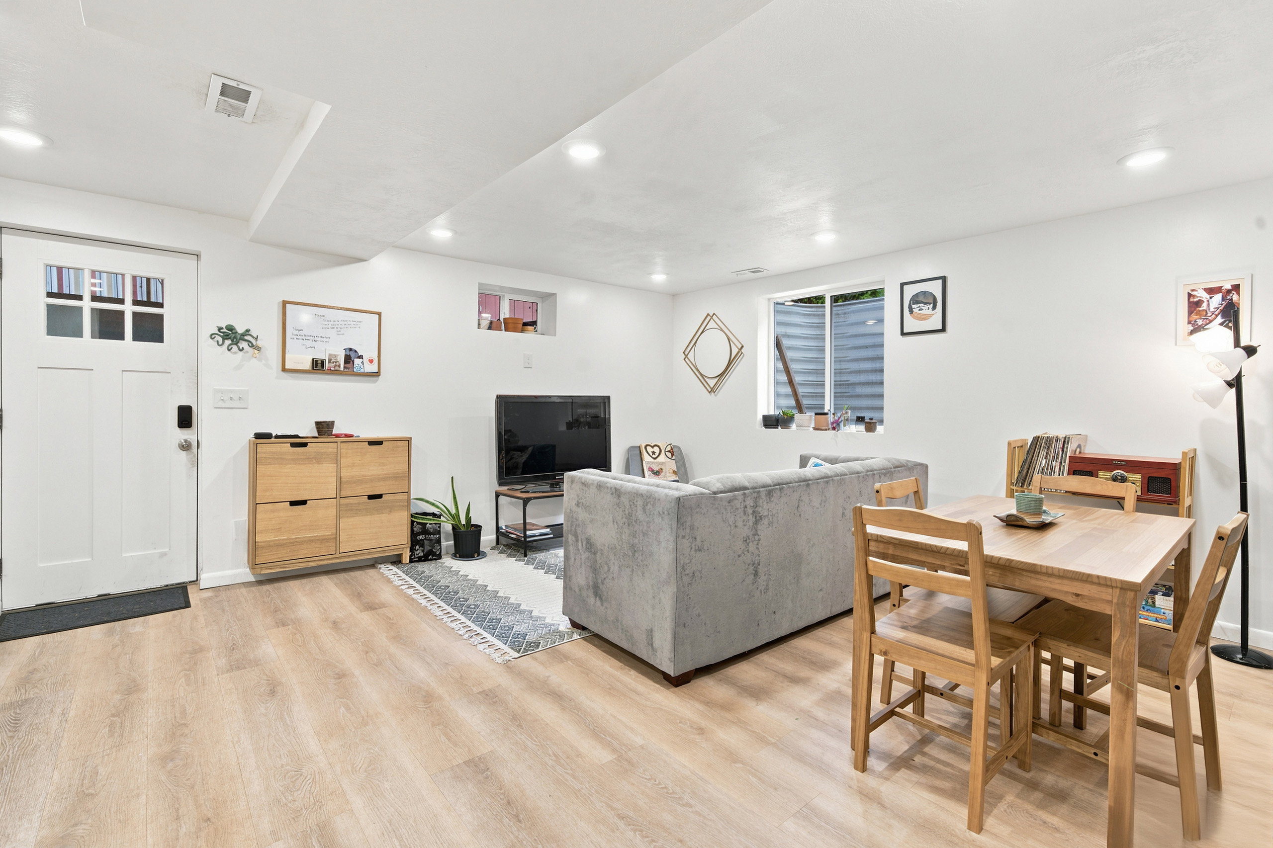 Spacious interior featuring light wood-finish flooring, recessed lighting, and white painted walls