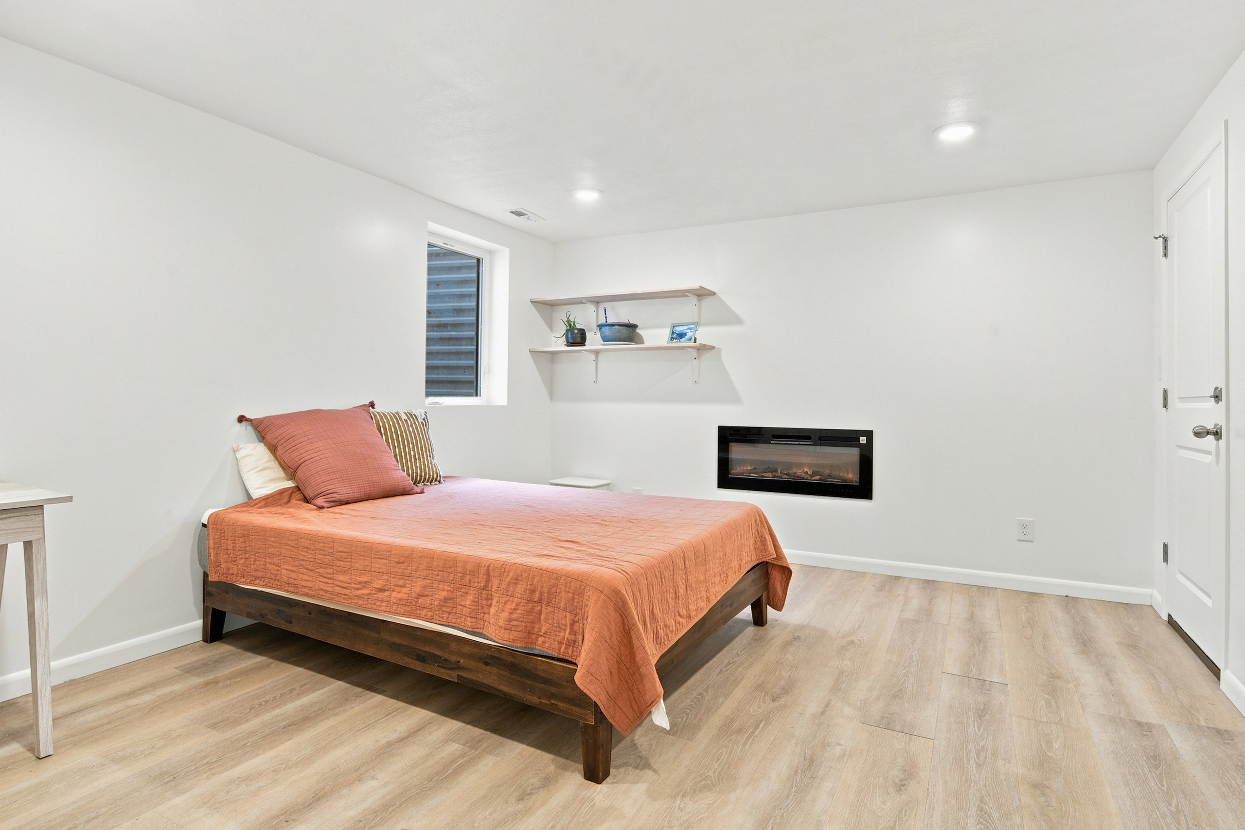 Room featuring light wood-finish flooring, recessed lighting, and a white interior door
