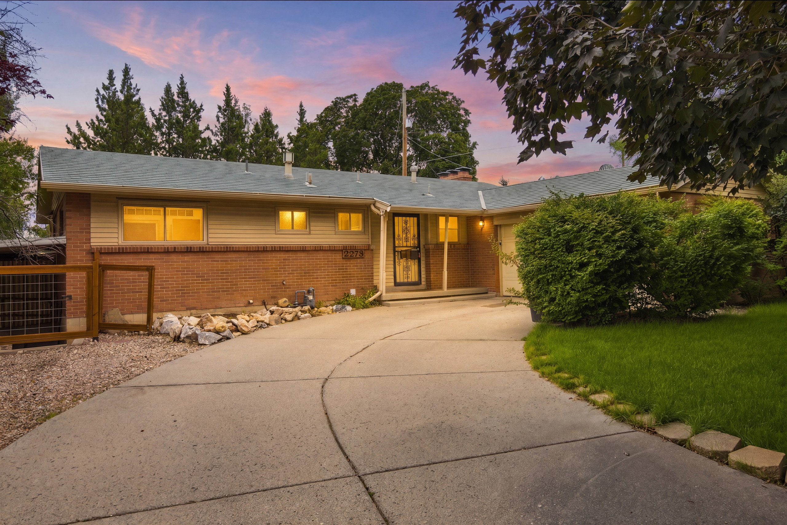 Ranch-style residence featuring a brick and siding exterior with a light blue shingle roof