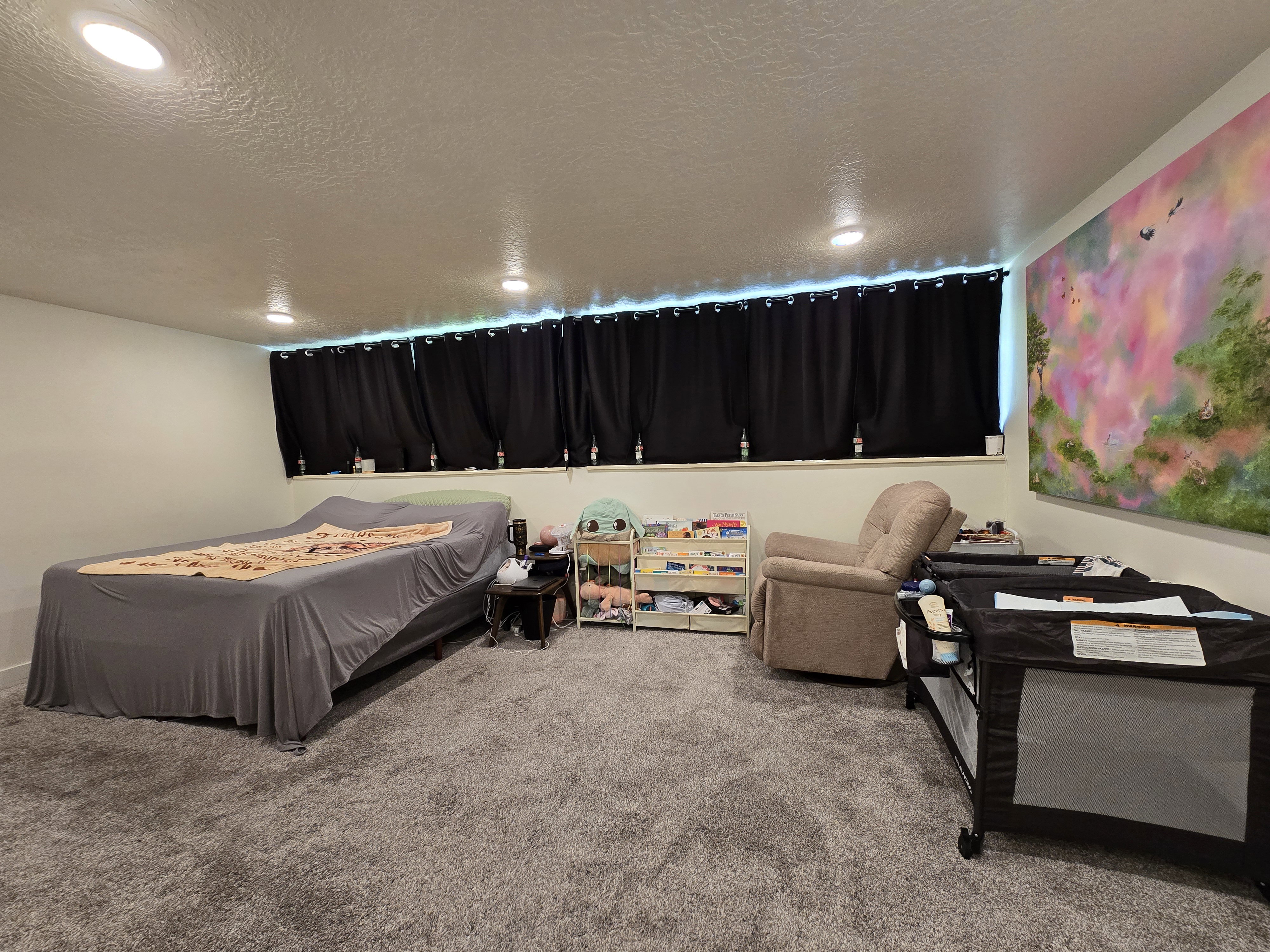 Carpeted interior space featuring recessed lighting, a window with blackout curtains, and light-colored walls