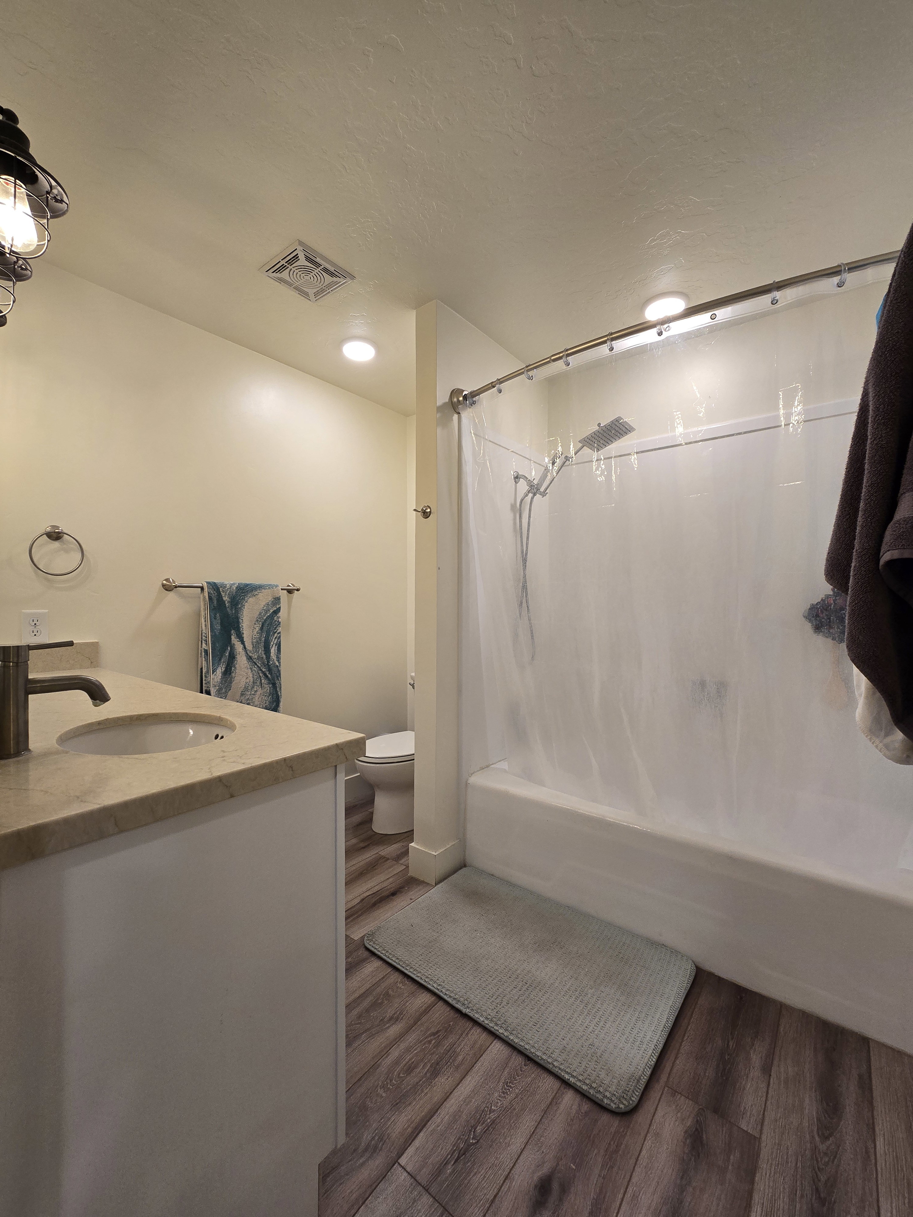 Bathroom featuring a white vanity with a light-toned countertop and an undermount sink