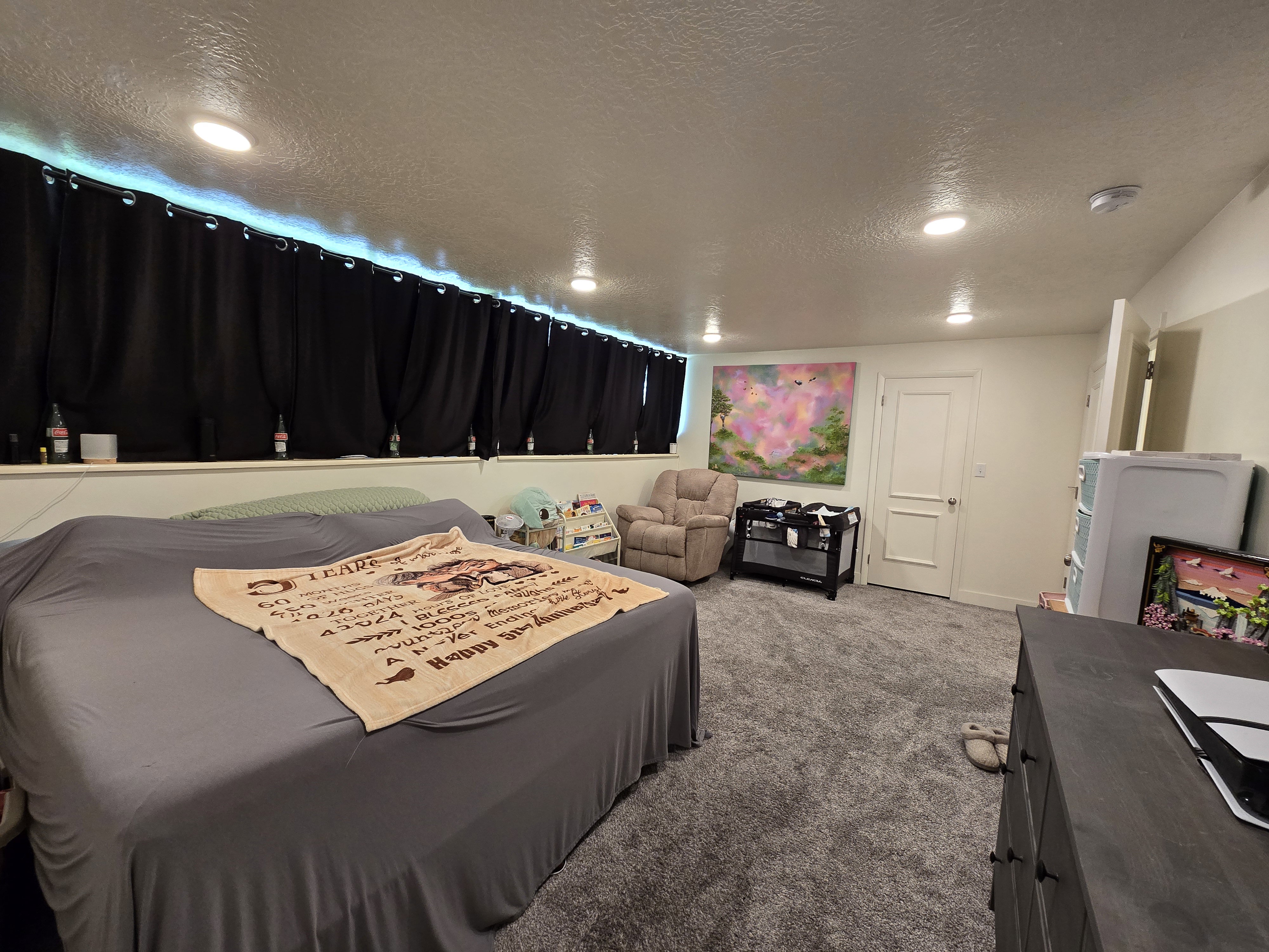 Spacious room featuring recessed lighting, plush grey carpeting, a white interior door, and a built-in shelf