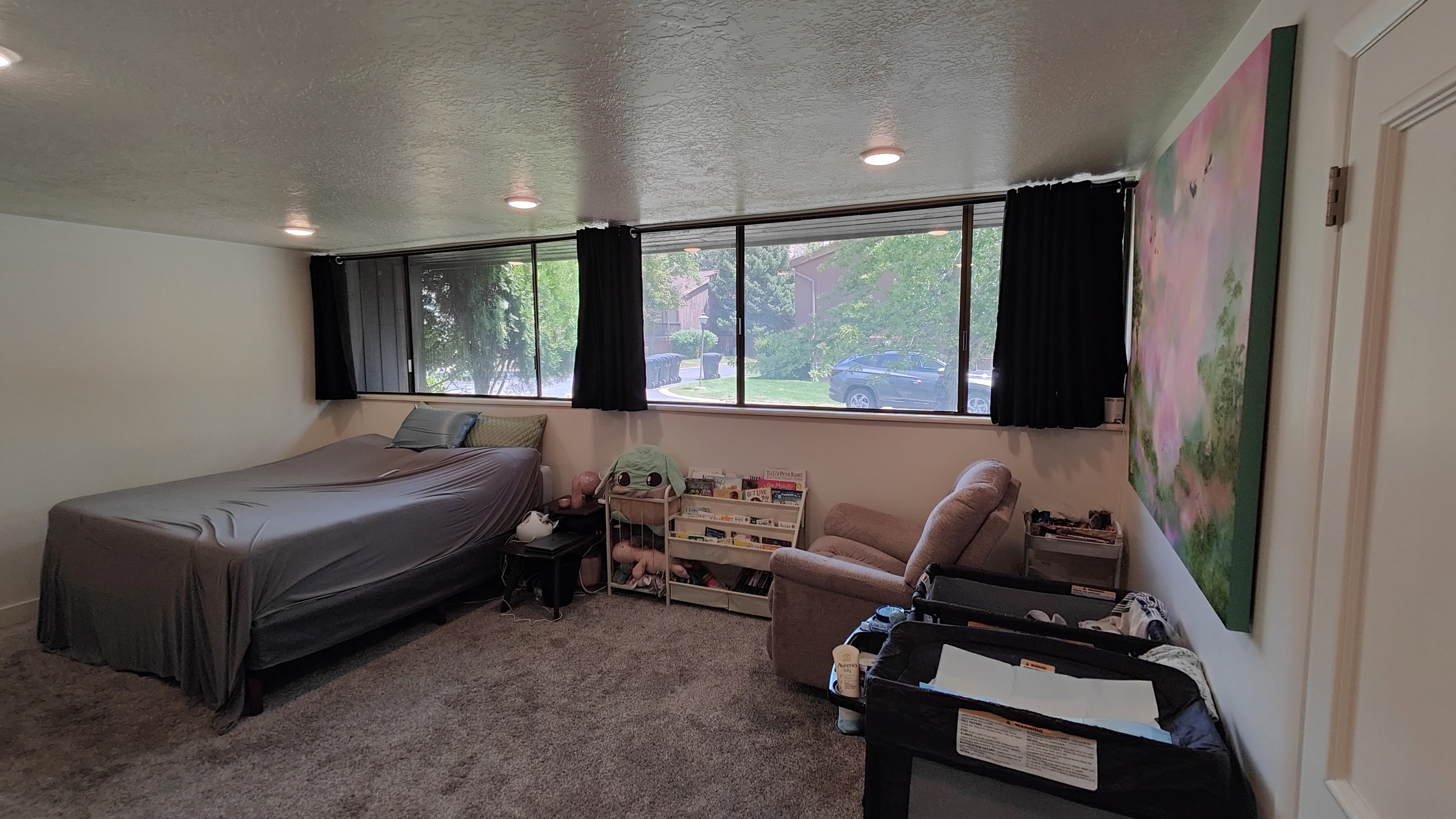 Wall-to-wall carpeting with recessed lighting and a row of horizontal windows