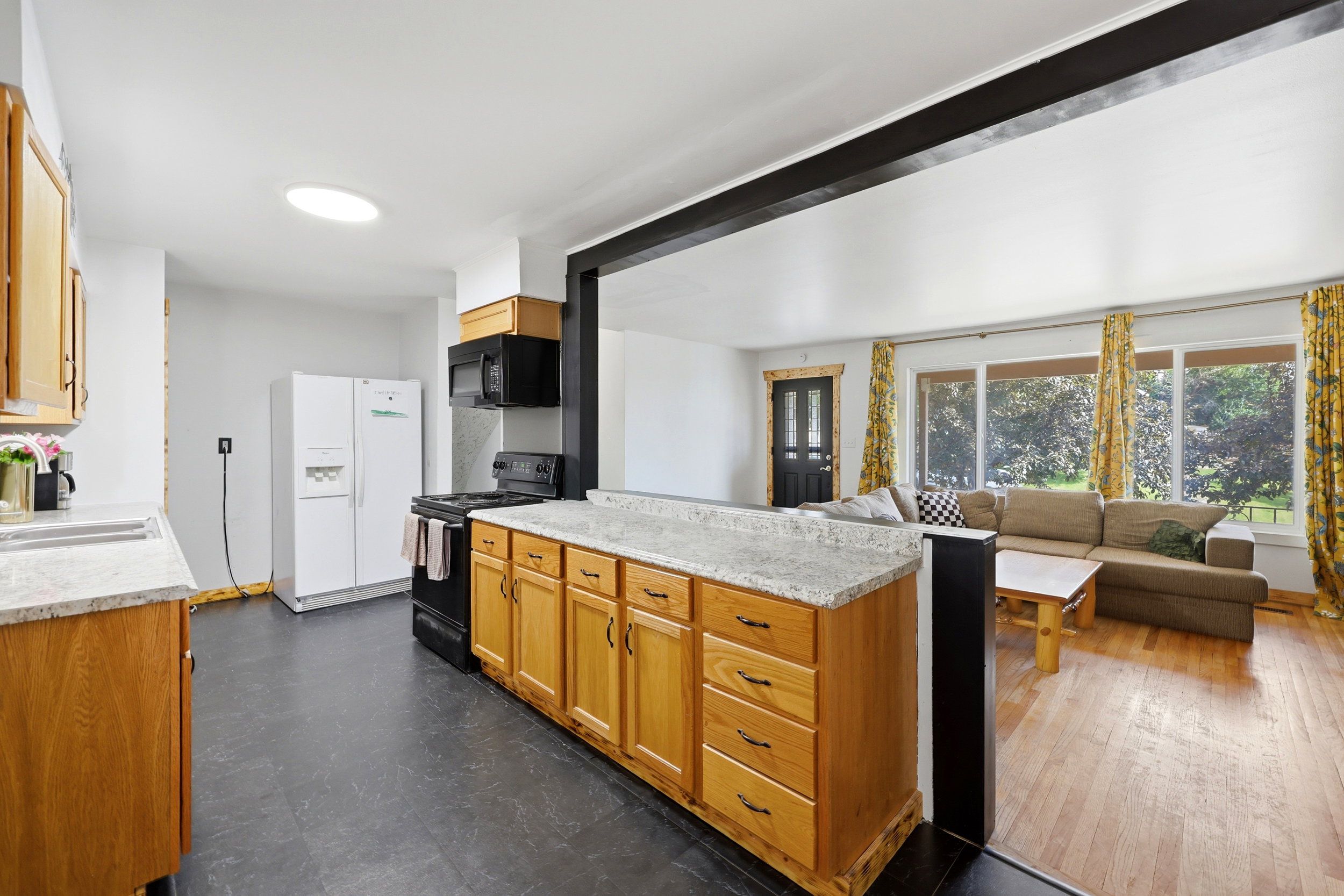 Kitchen island with light-toned cabinetry and a speckled countertop