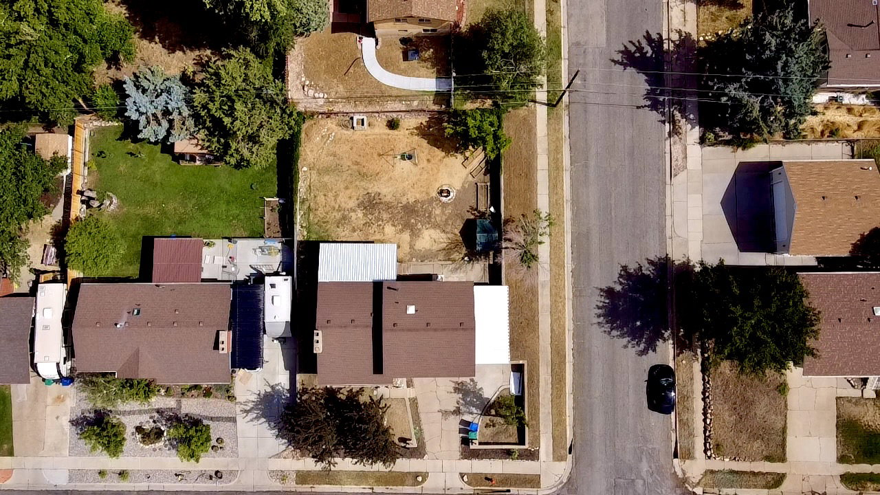 Aerial perspective showcasing a residential street with multiple properties