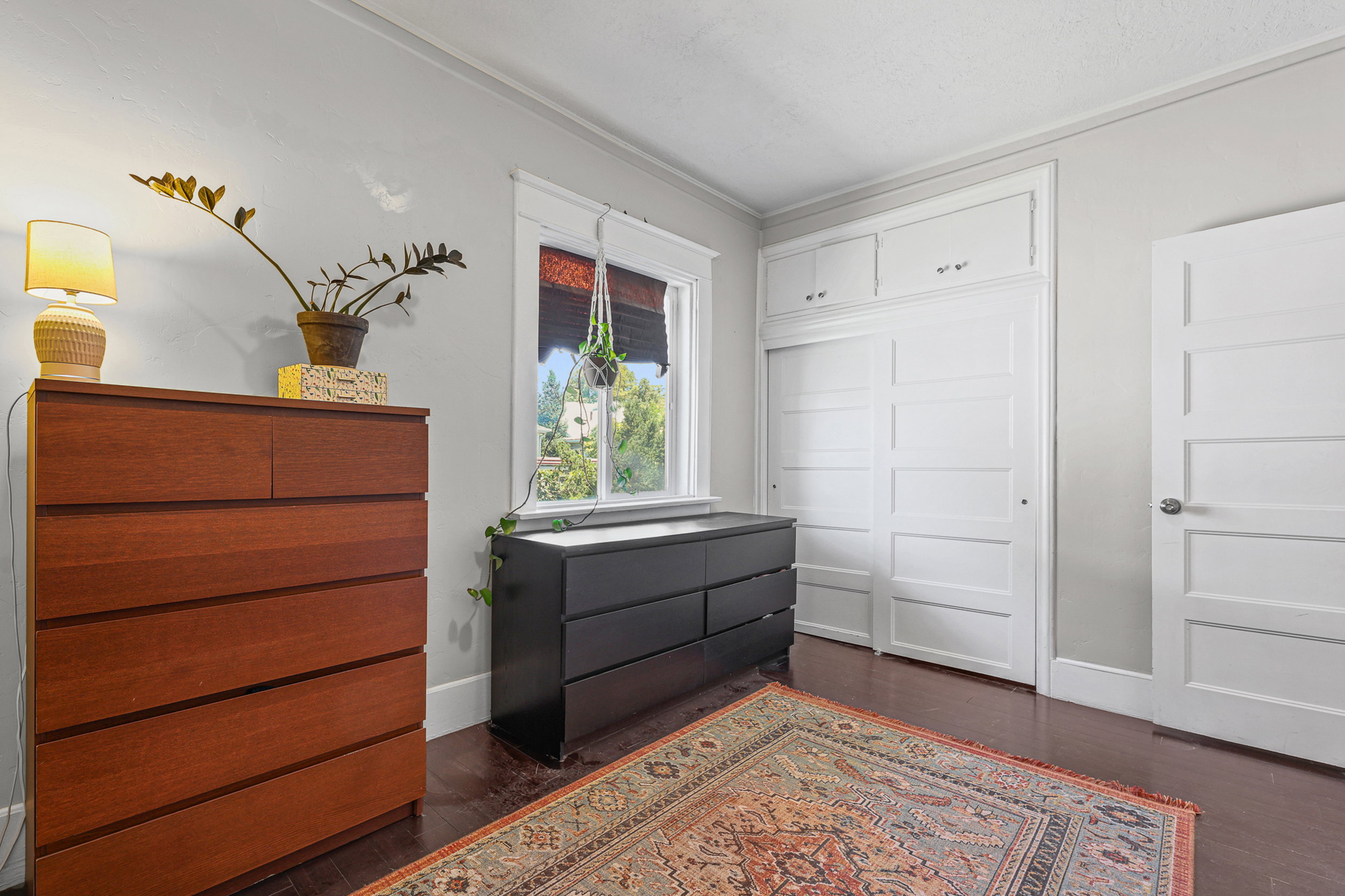 Hardwood-style flooring complementing light gray wall tones