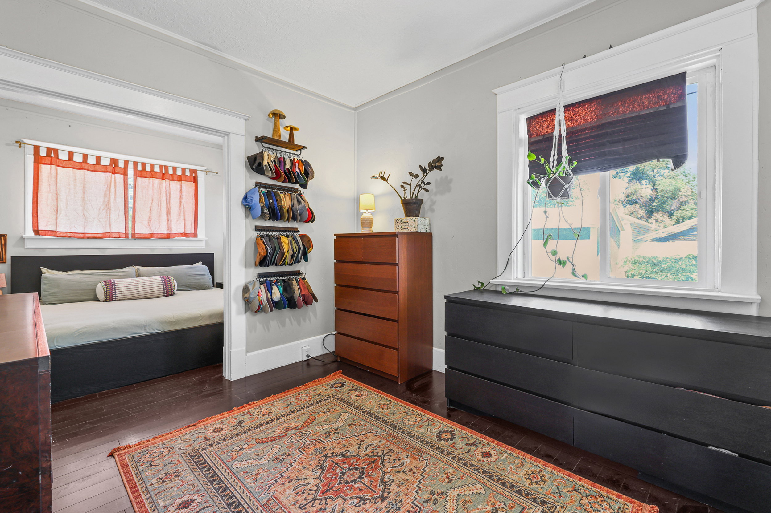 Spacious room featuring wood-finish flooring, a white-trimmed window, and a recessed area with a second window
