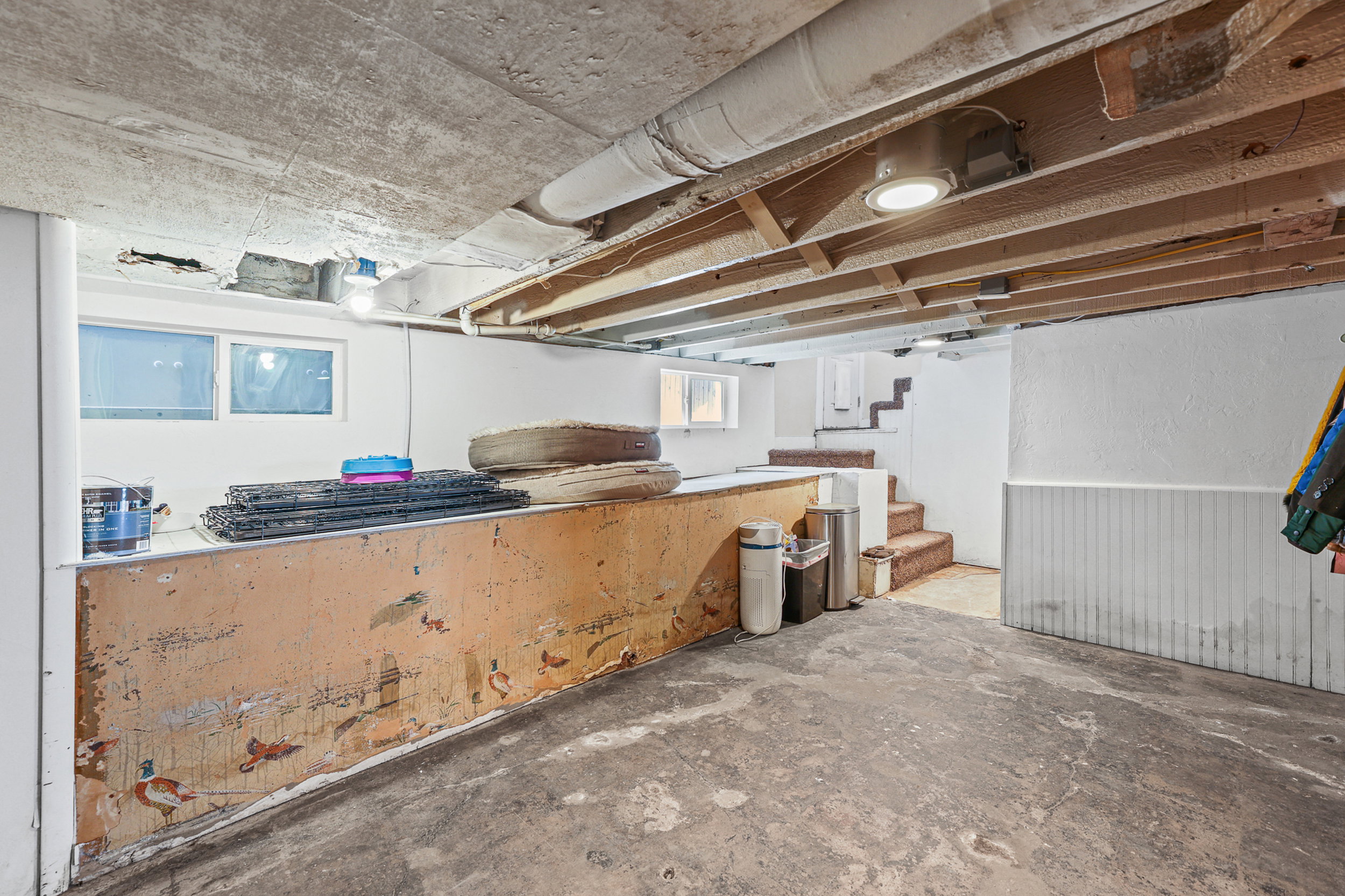 Concrete flooring with exposed ceiling joists