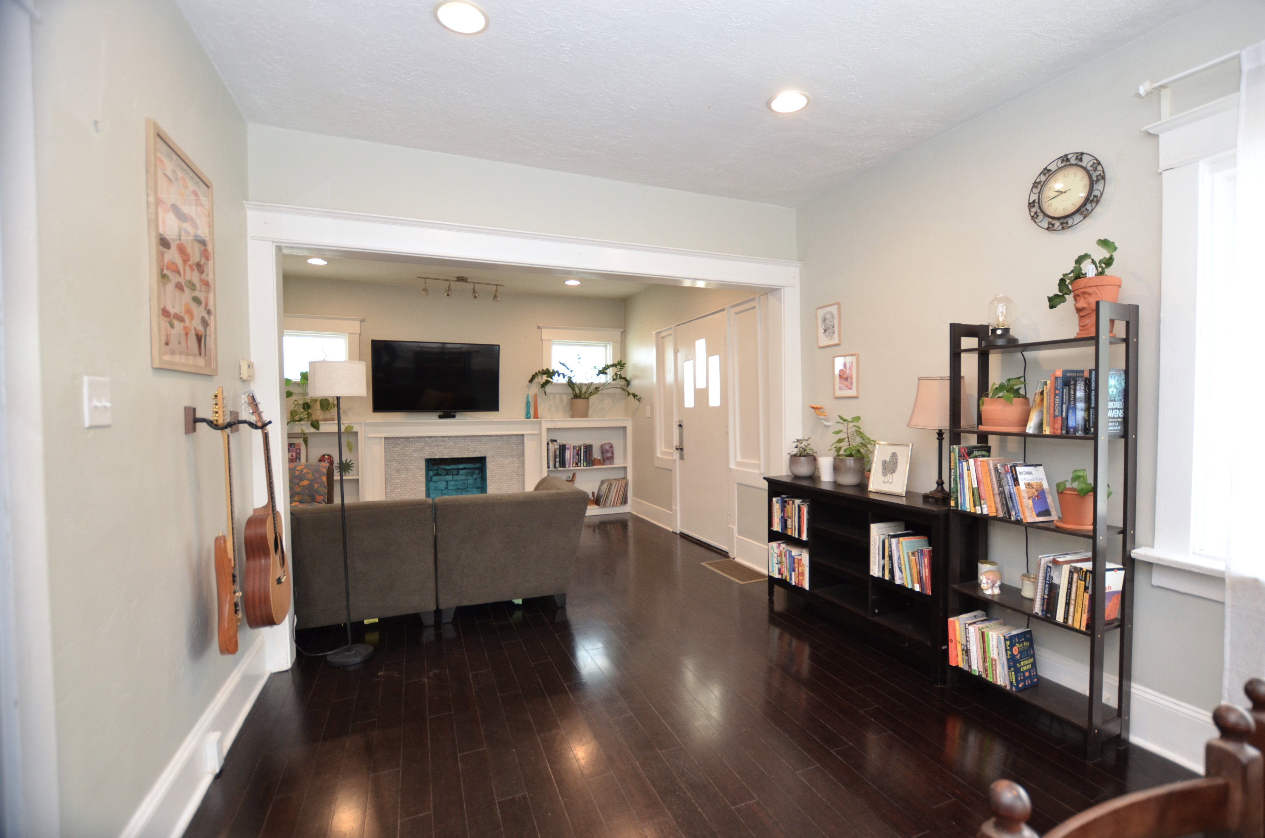 Open-concept living area with dark wood-finish flooring